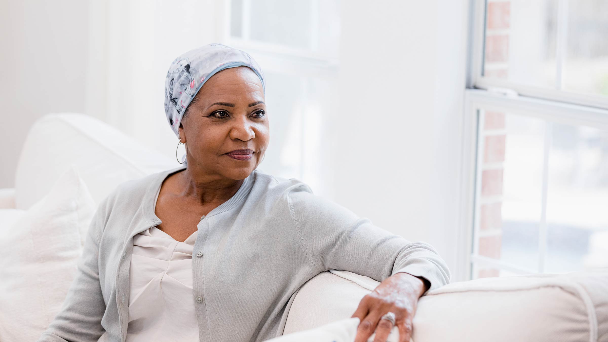 Confident woman, cancer patient, sitting on a couch