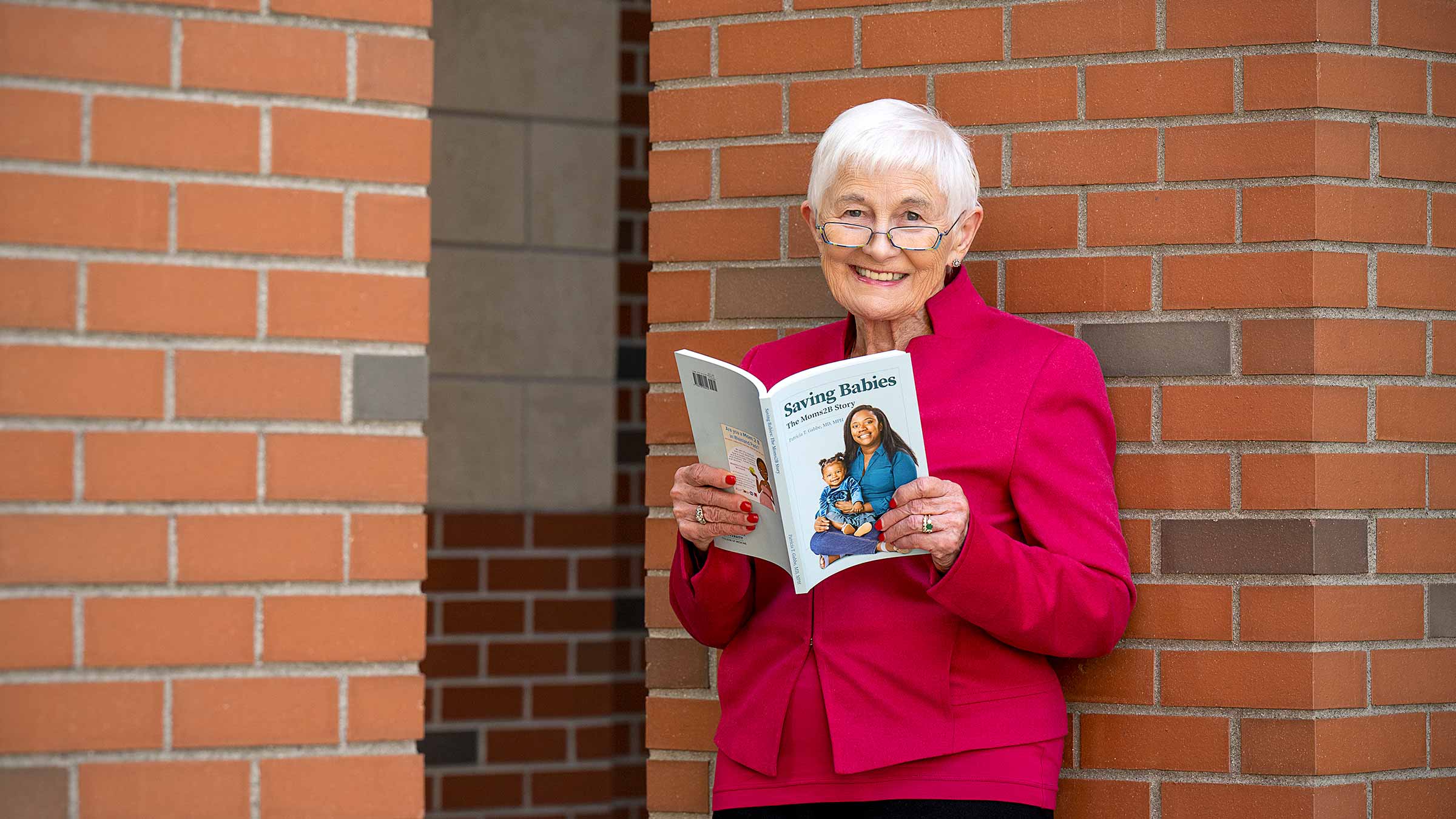 Dr. Gabbe holding her book