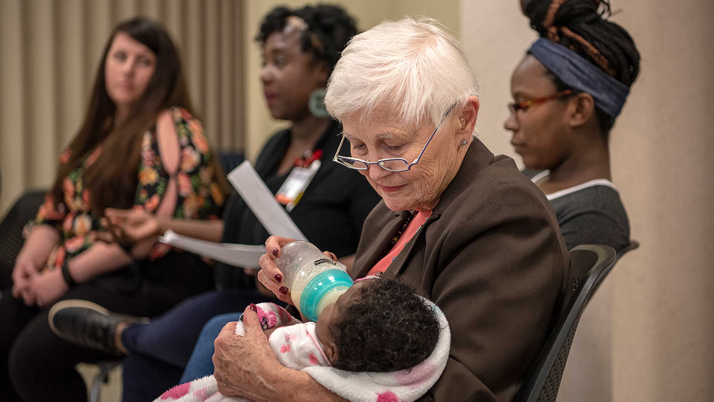 Dr. Gabbe is feeding a baby