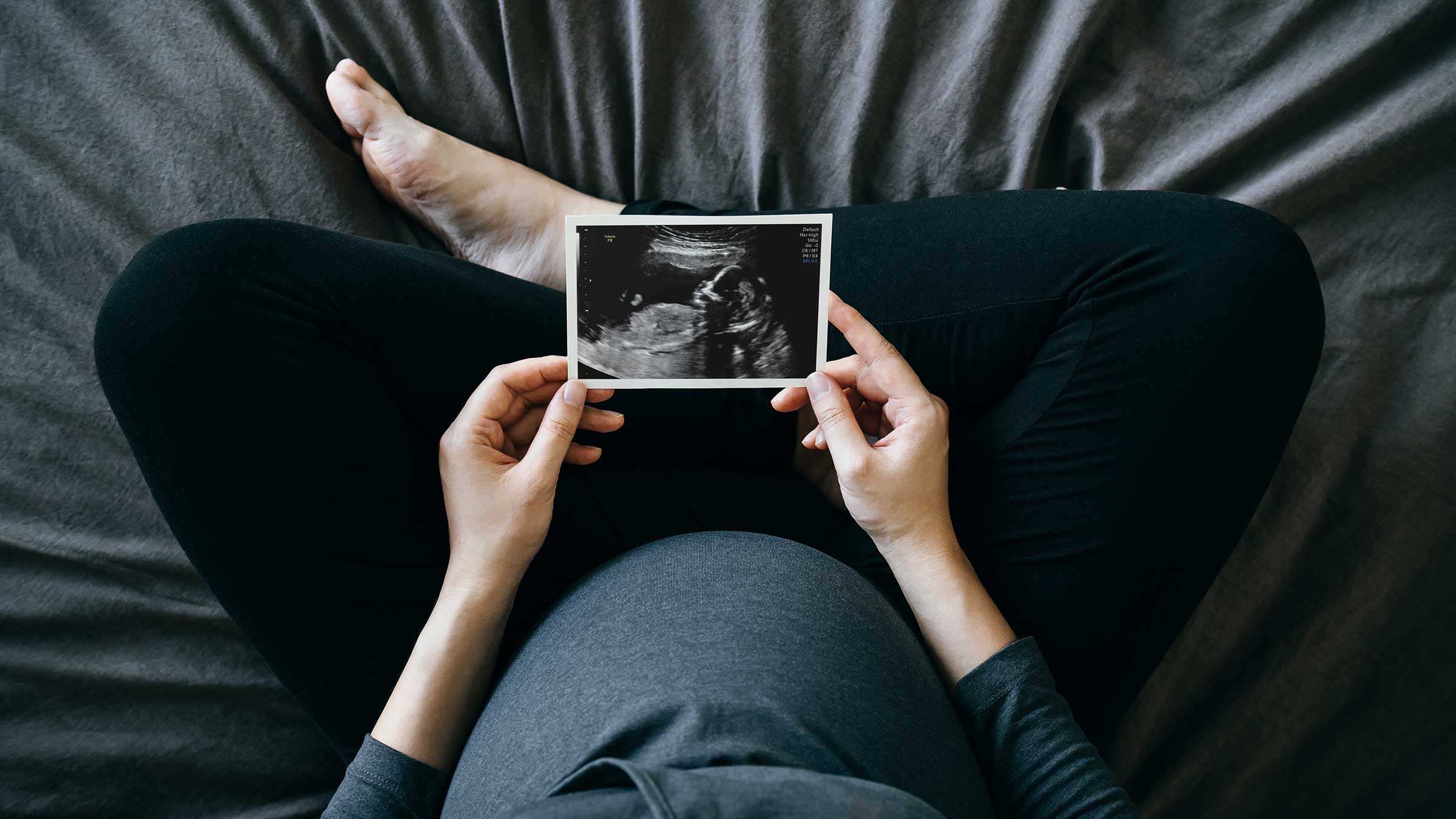 Pregnant woman looking at an ultrasound photo