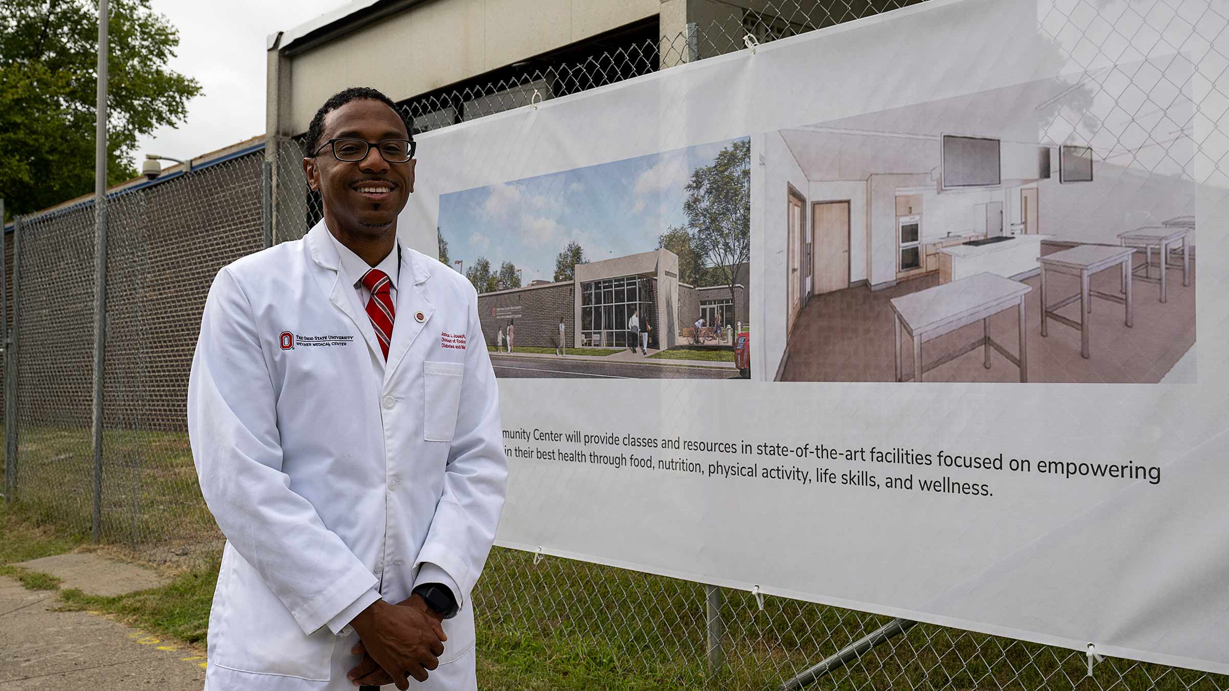 Dr. Joseph standing next to construction site
