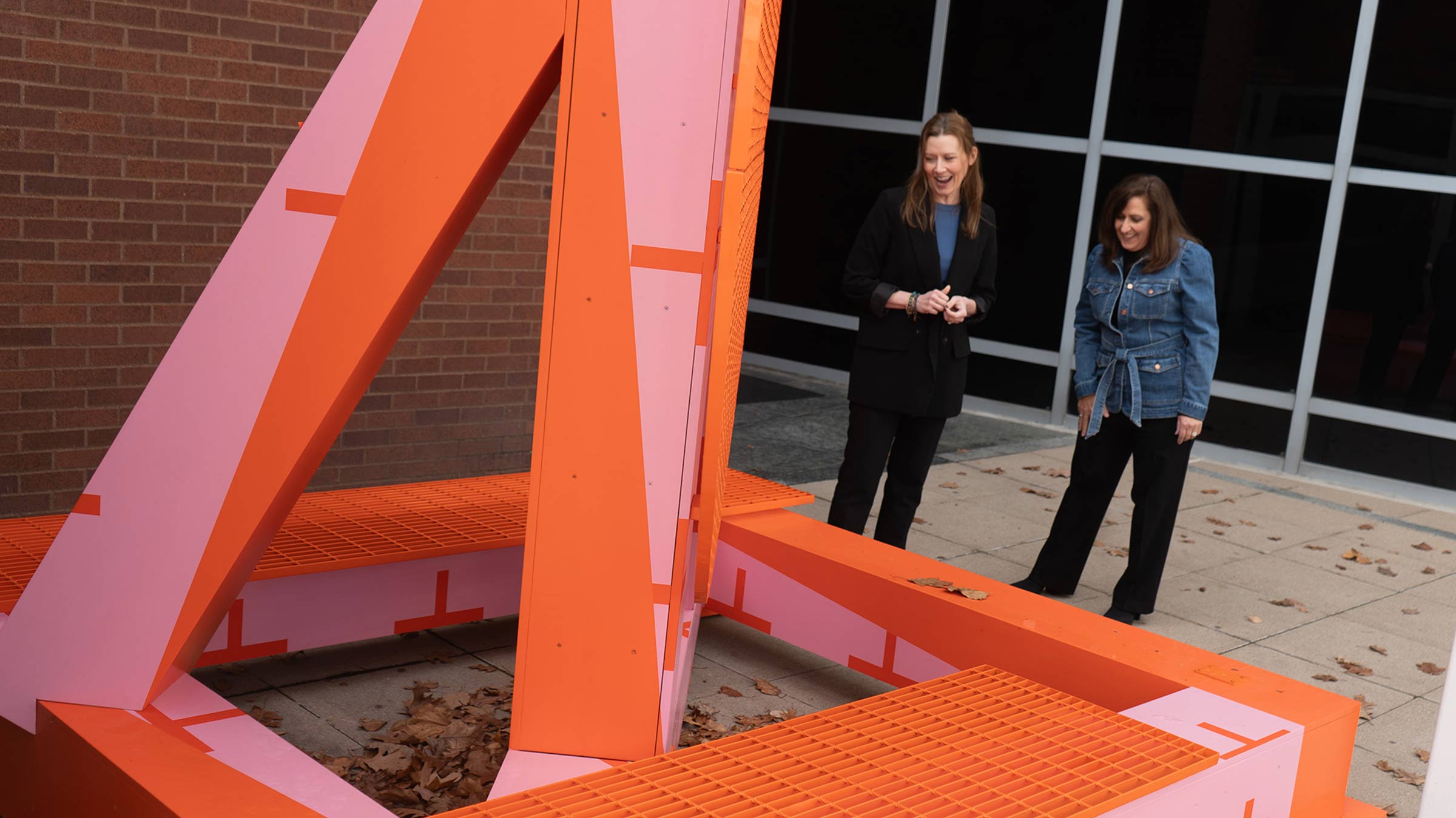 Kim talking to Tracie McCambridge while admiring an art piece