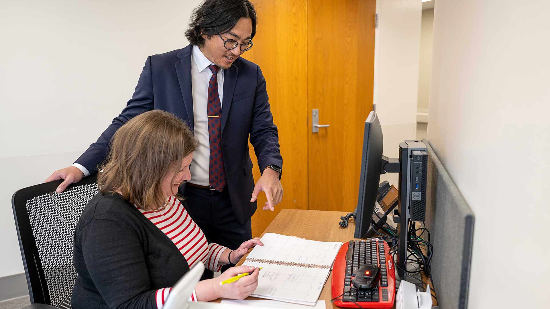 Dr. Alex Kim with Joyce Buckley looking over the calendar