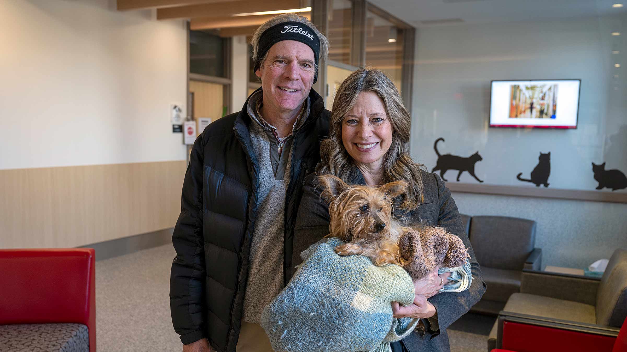 Dr. Acton and her husband holding Winnie in the clinic lobby