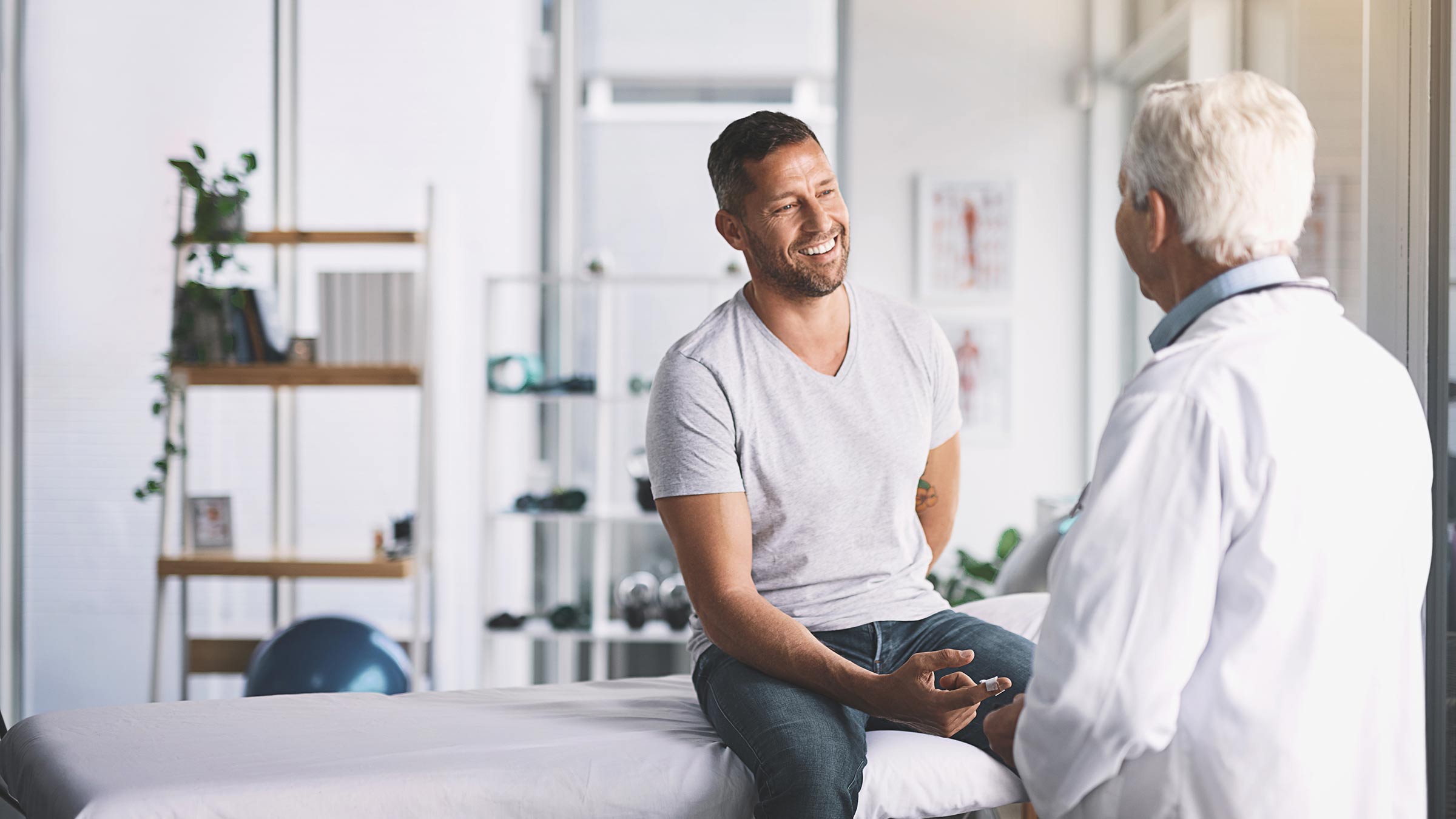 An adult male meeting with a physician