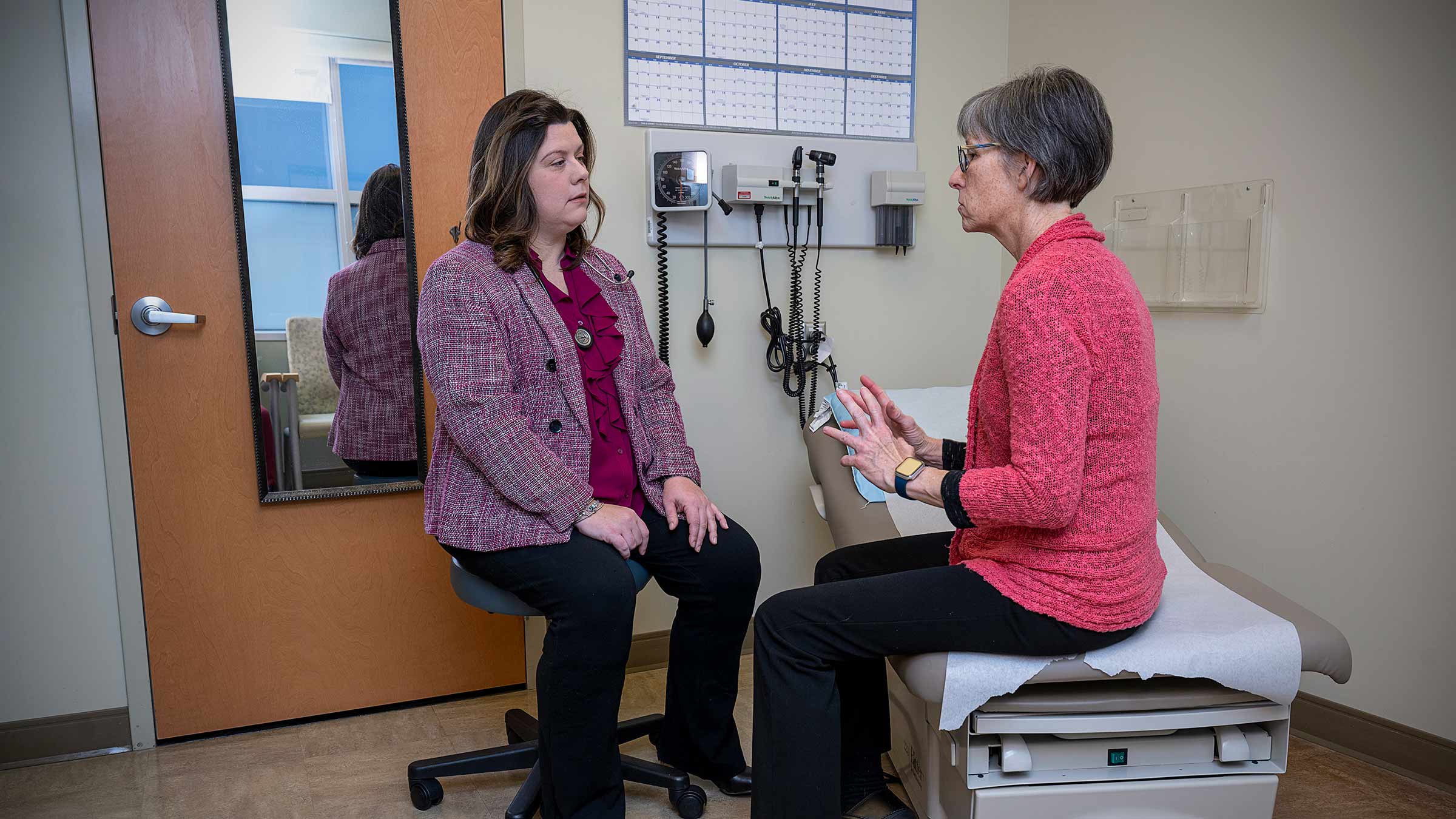 Dr. Nicole Williams talking to a female patient