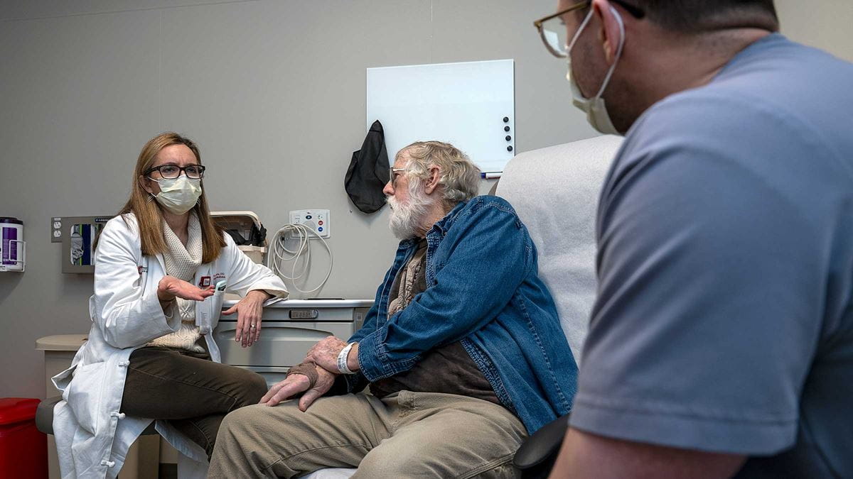 Patient Ted Spellmire talking to a doctor in the exam room