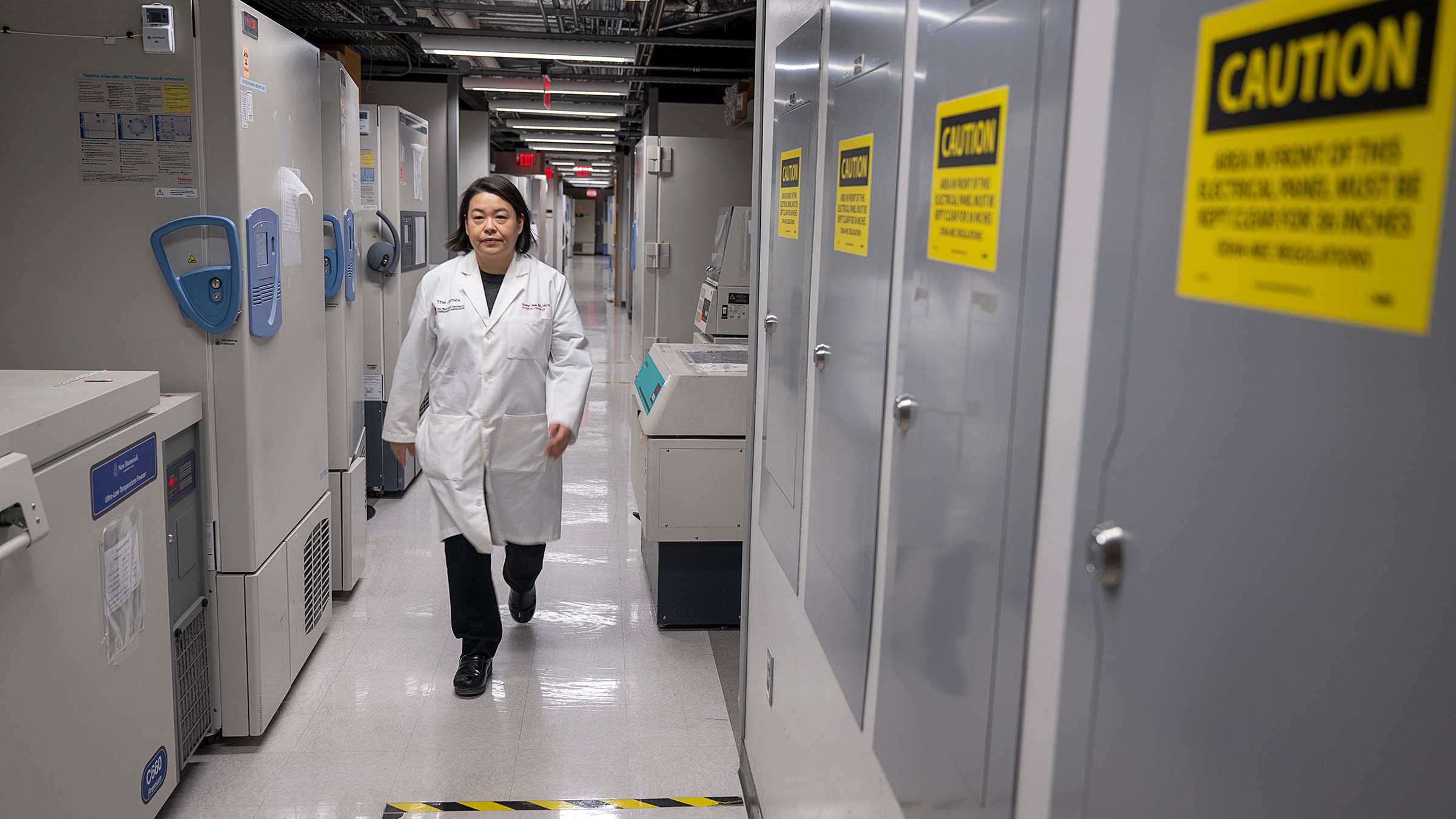 Dr. Tsai walking along the corridor in the lab