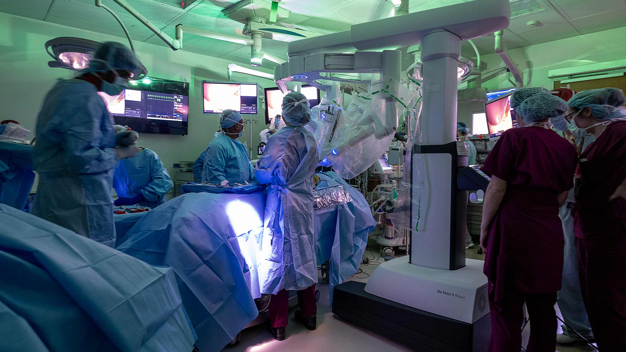 The da Vinci 5 robot and a surgical team in the OR