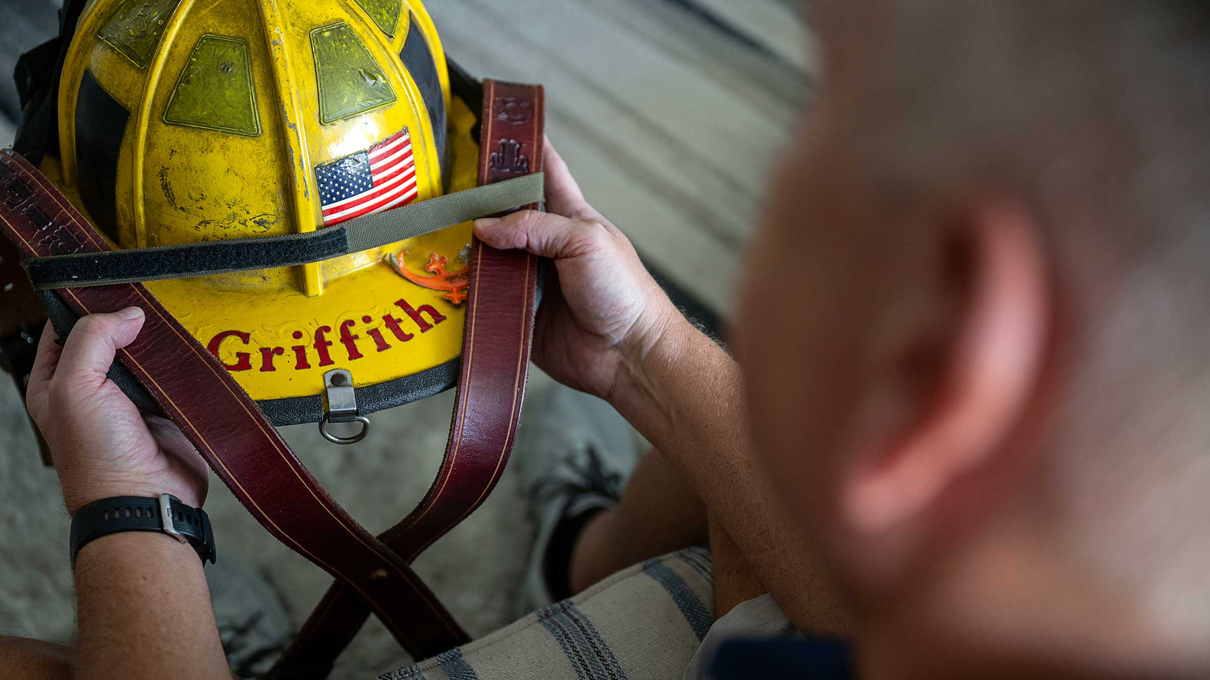 Scott Griffith holding his old firefighter helmet