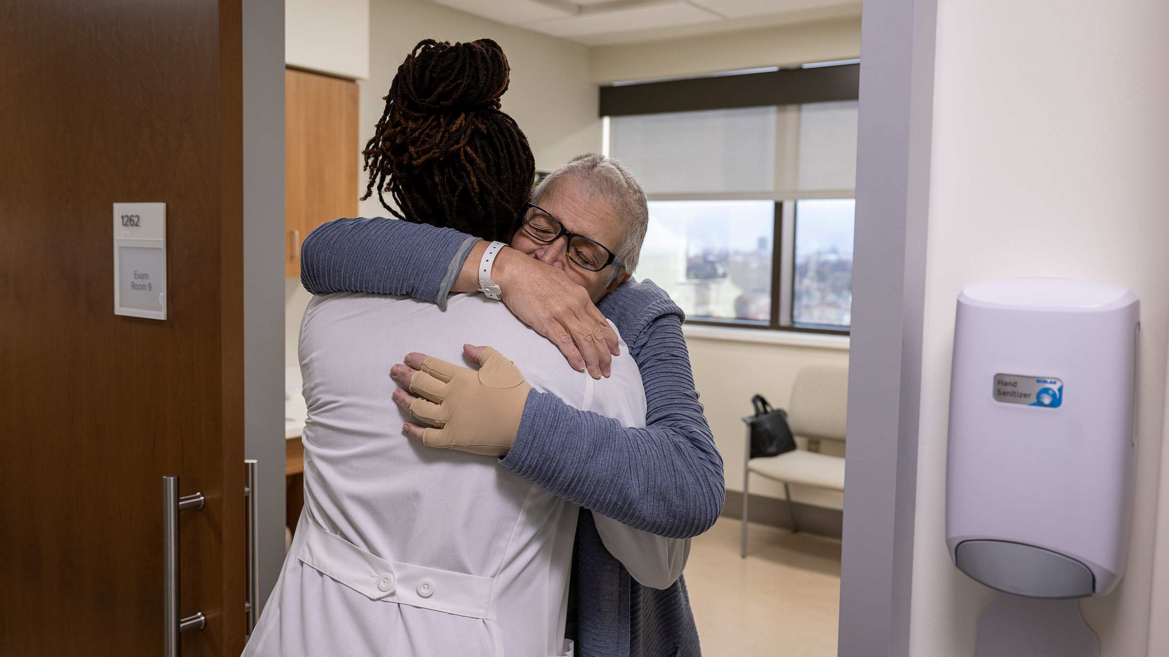 A patient, Vicki Rich, hugs Dr. Kerry-Ann Mitchell
