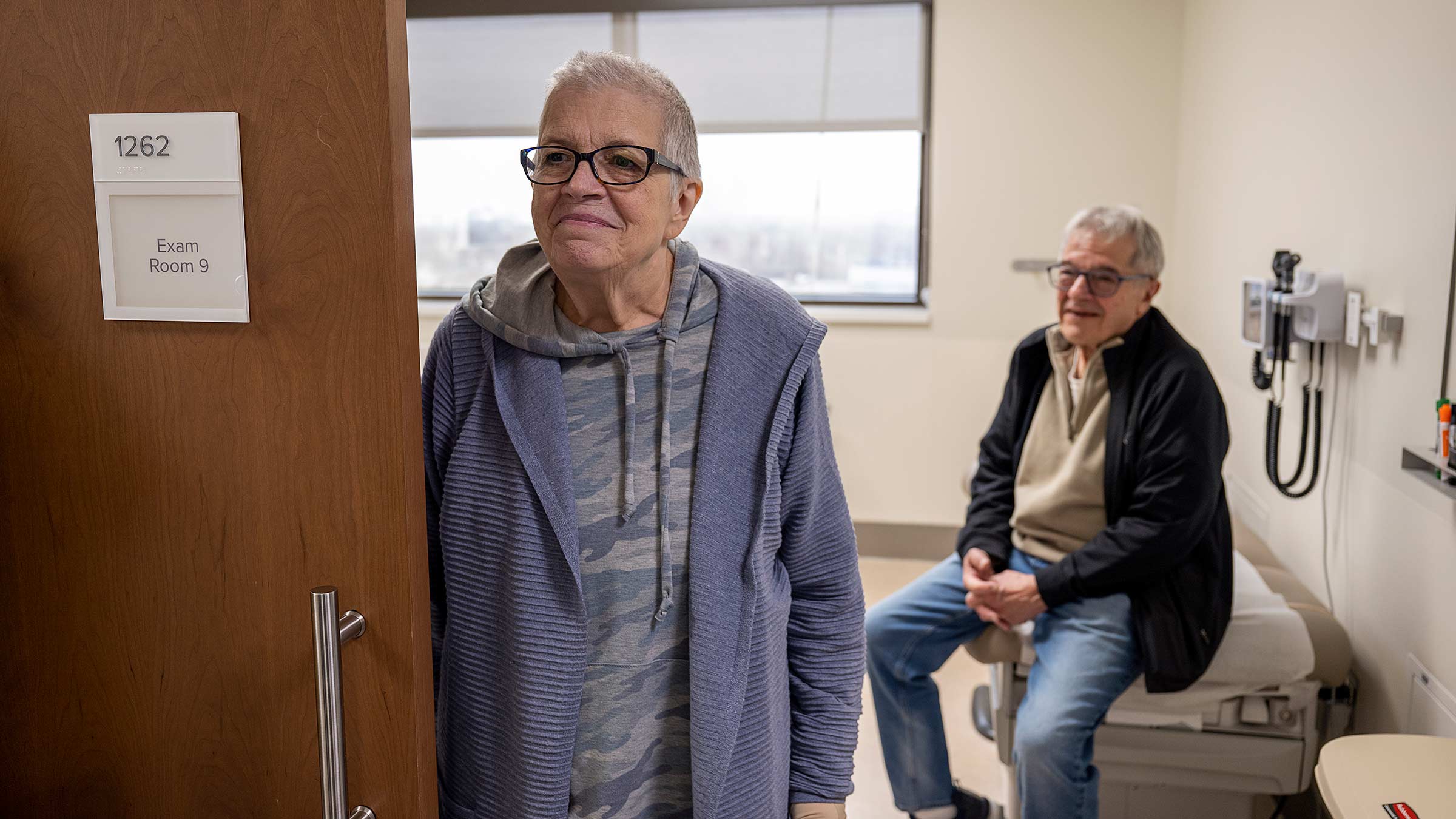 Vicki Rich, a skull reconstruction patient, and her husband wait in an exam room during a post-operative visit