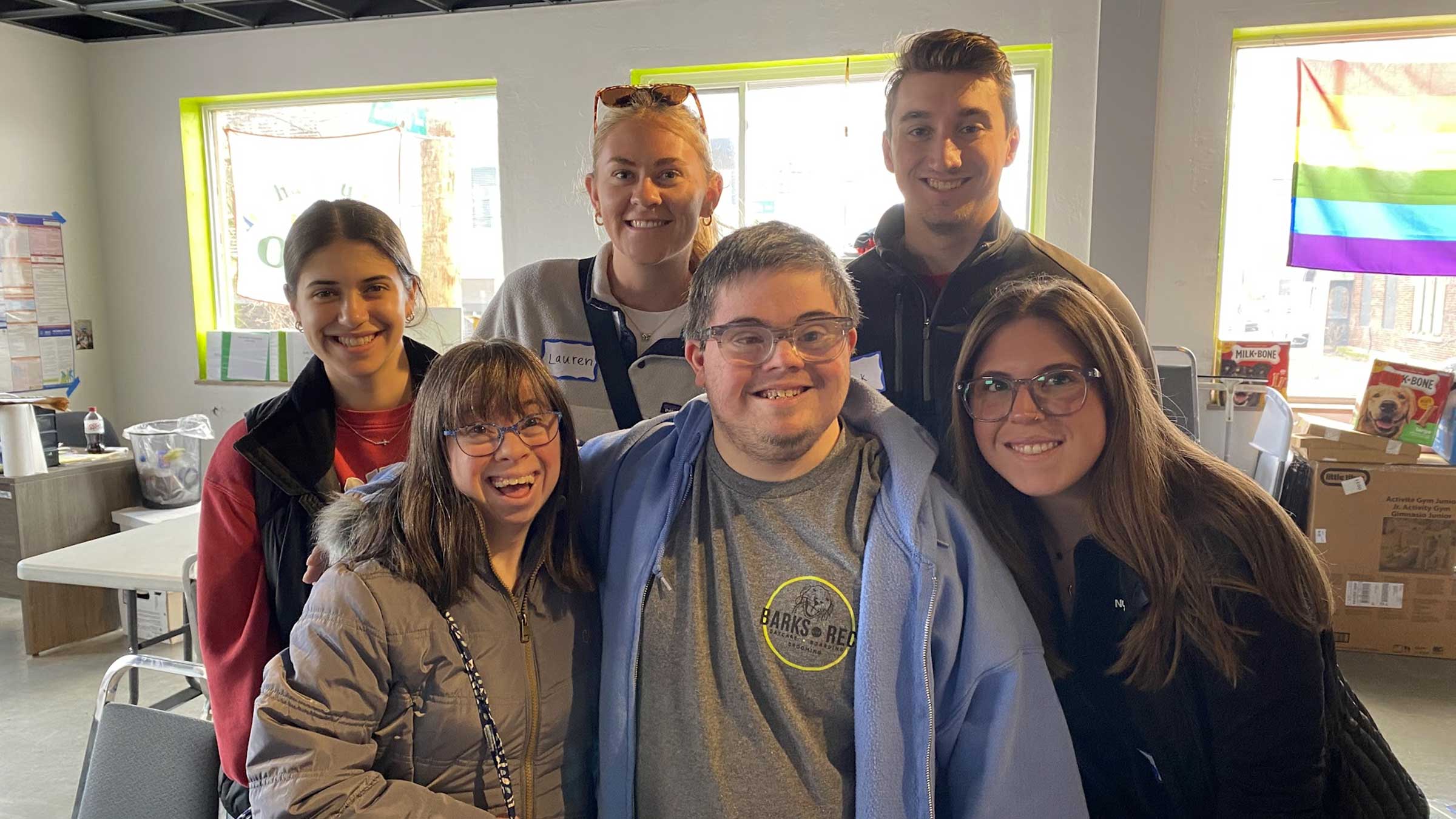 Ohio State HRS students and young people with down syndrome volunteering together at Barks and Rec, a dog daycare