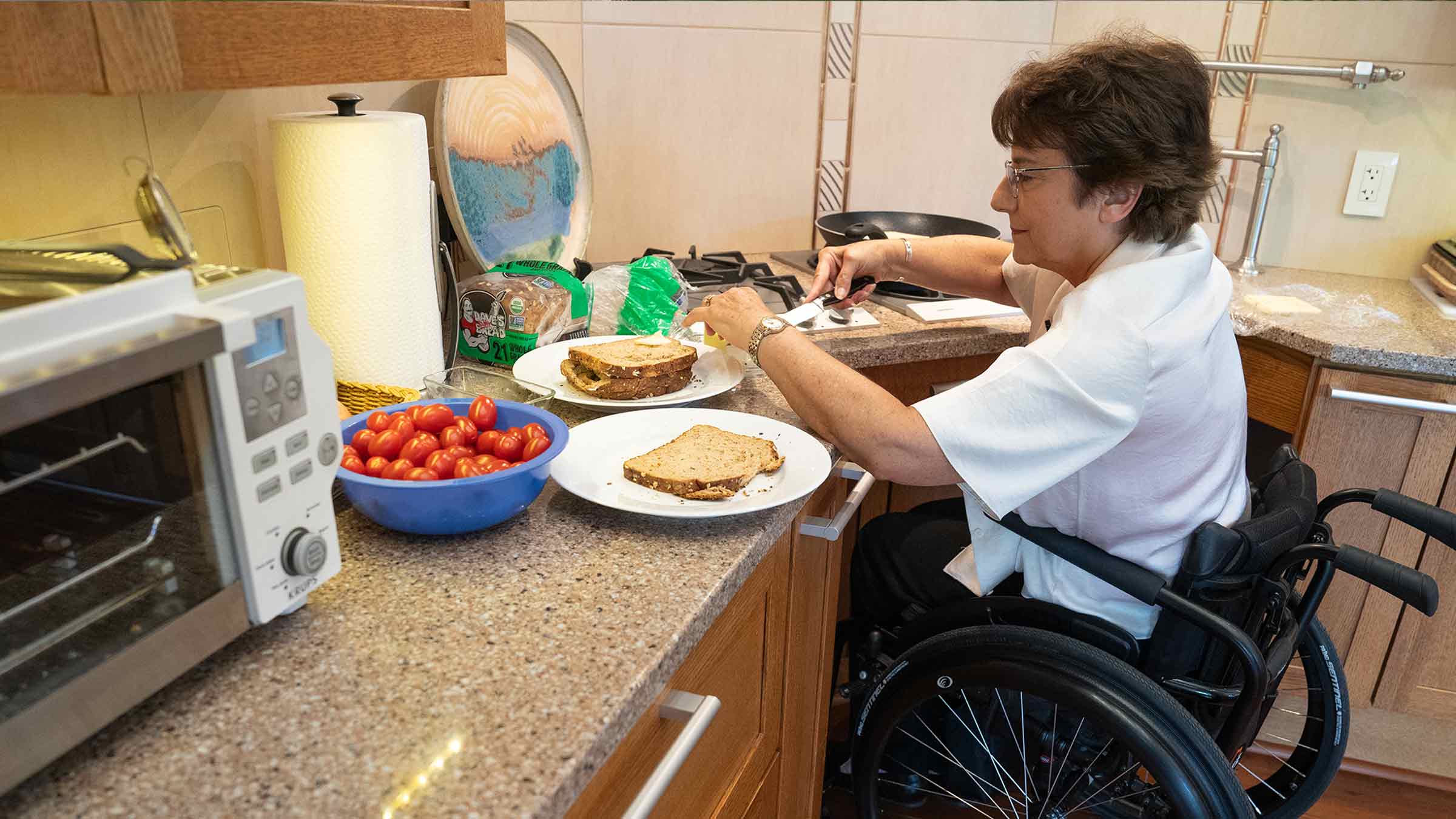 Rosemarie Rossetti sits in her wheelchair in the kitchen making food