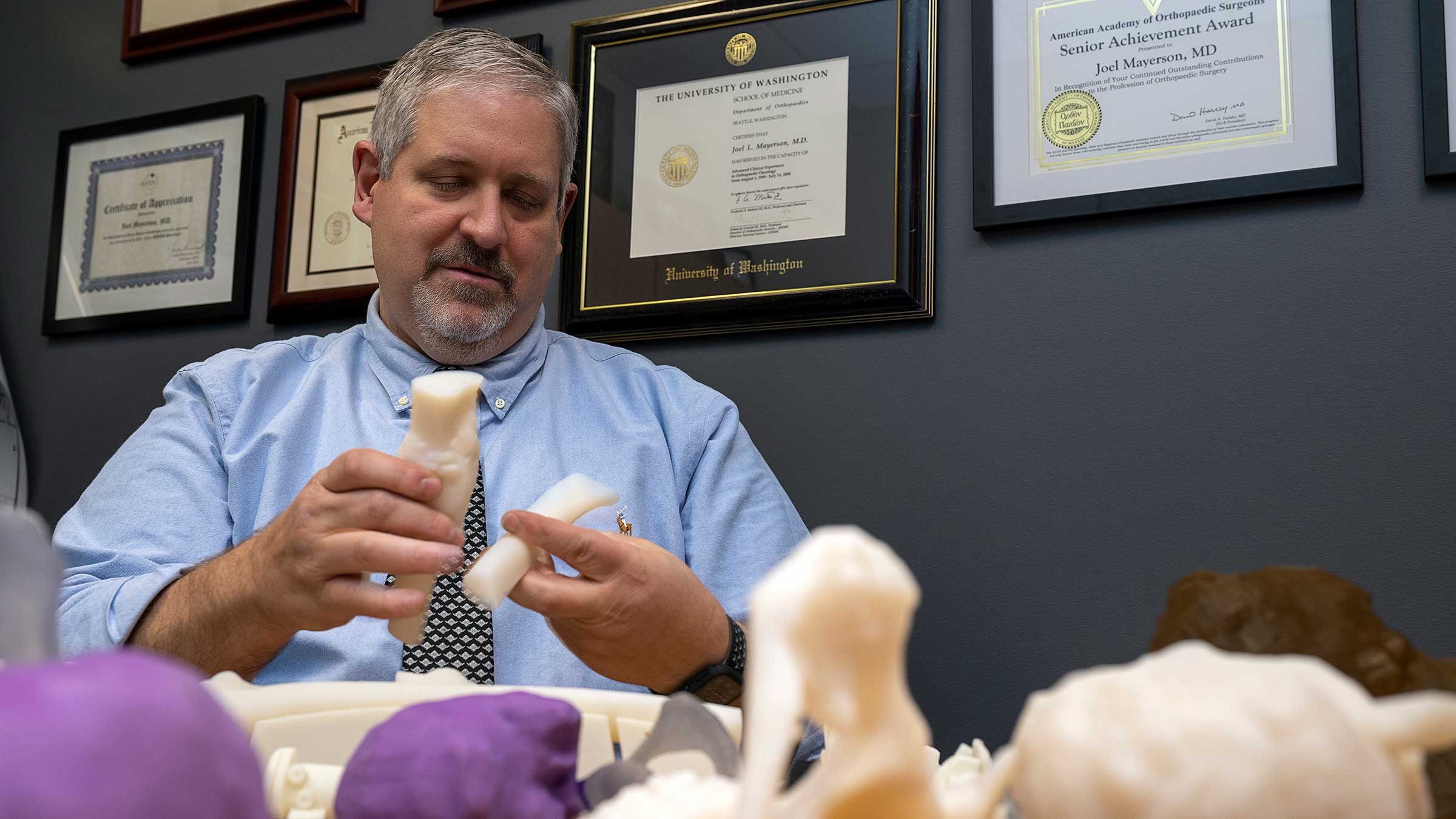 Dr. Mayerson holding 3D printed models in his hands