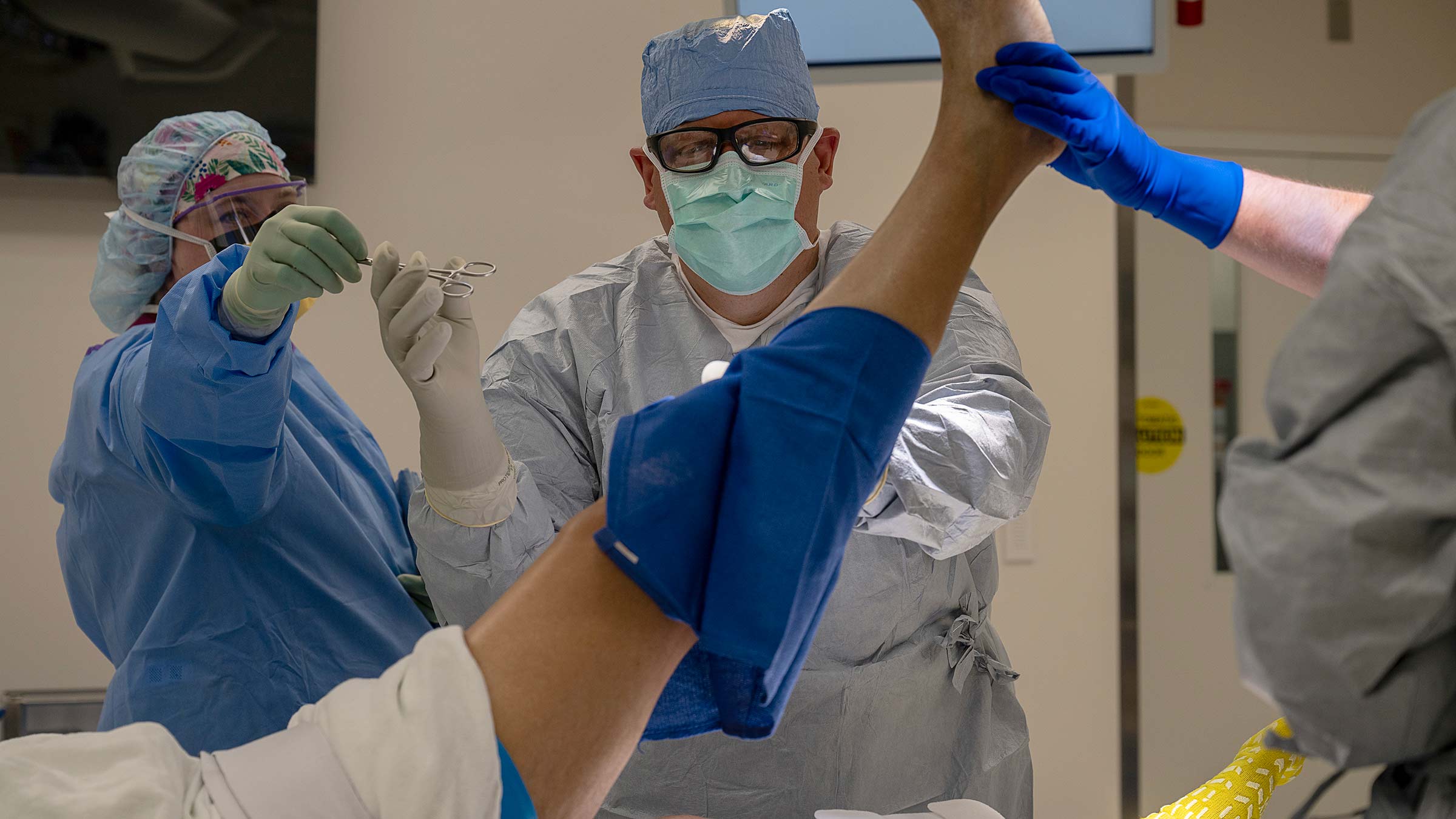 Dr. Joel Mayerson in an OR performing surgery on a leg