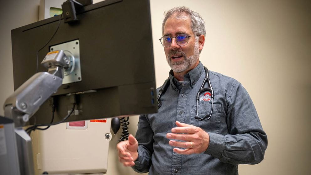 Dr. Aaron Clark at the computer at the hospital