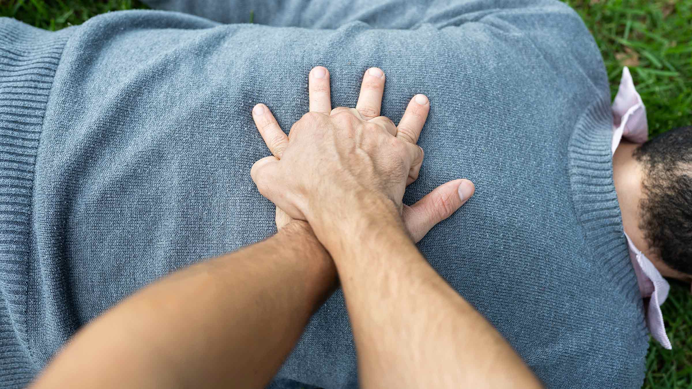 Hands on a man's chest, showing how to perform indirect heart massage