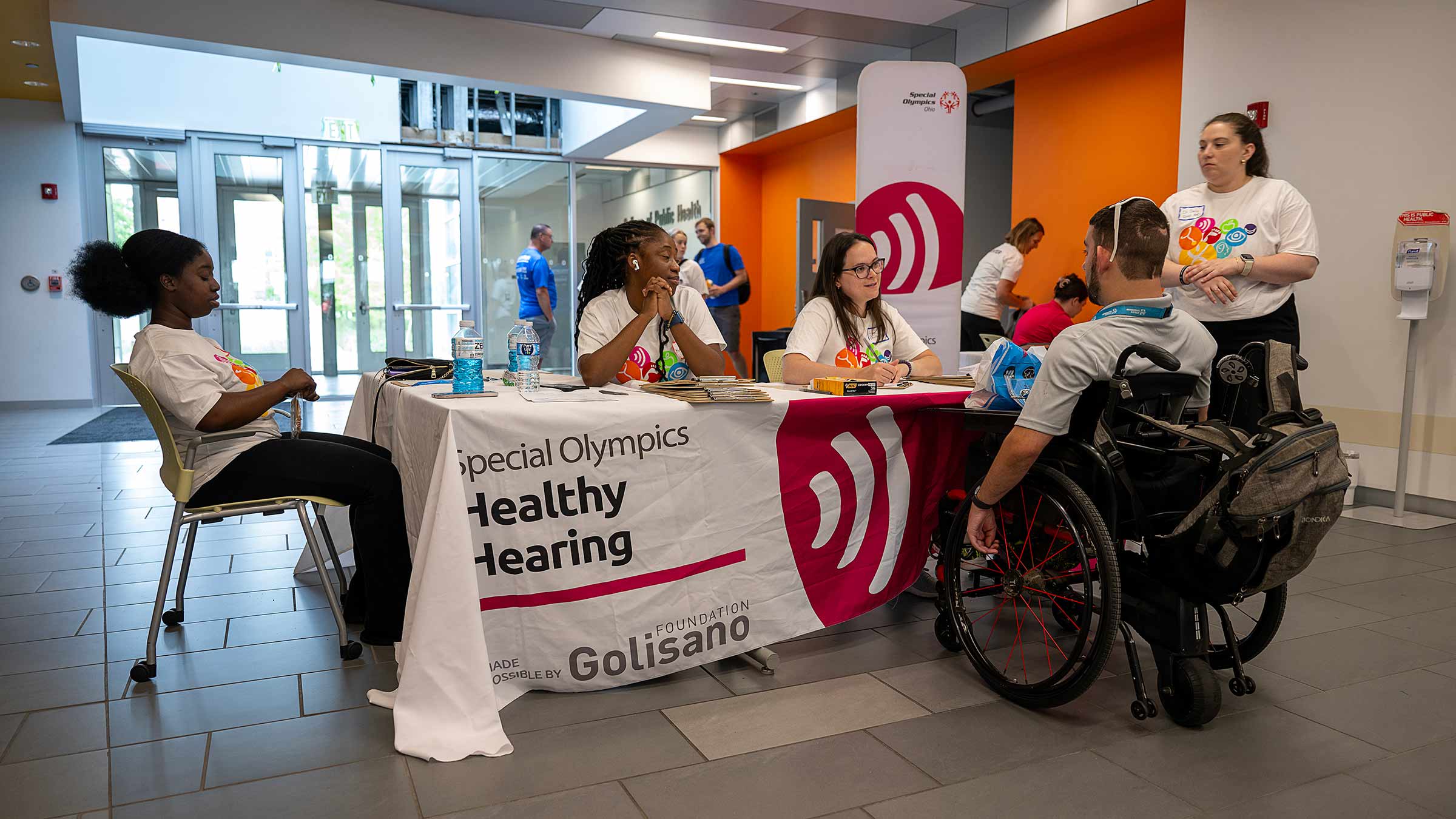 An athlete in a wheelchair at the Healthy Hearing screening station