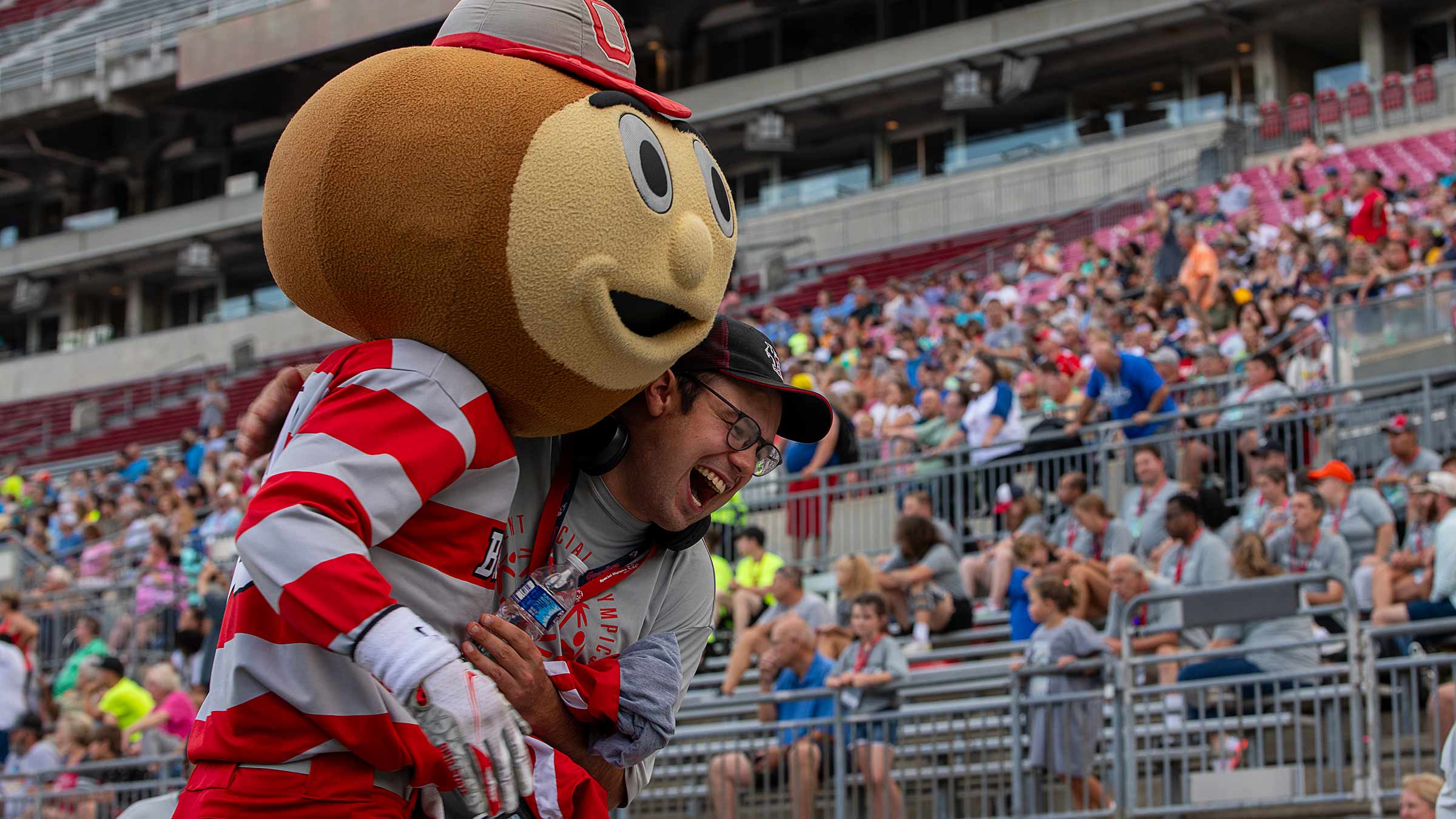 Brutus Buckeye hugging a Special Olympics participant