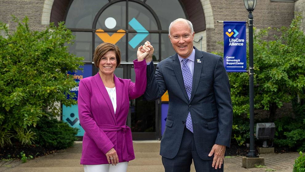 Amy Kerger and Charles Gehring shaking hands in celebration