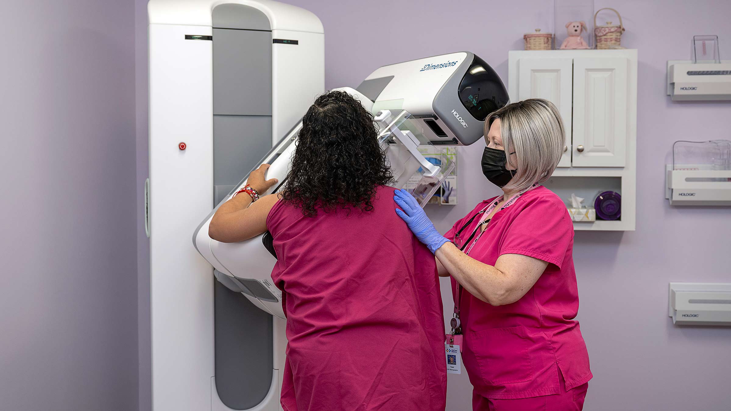 Medical technician helping a woman getting a mammogram