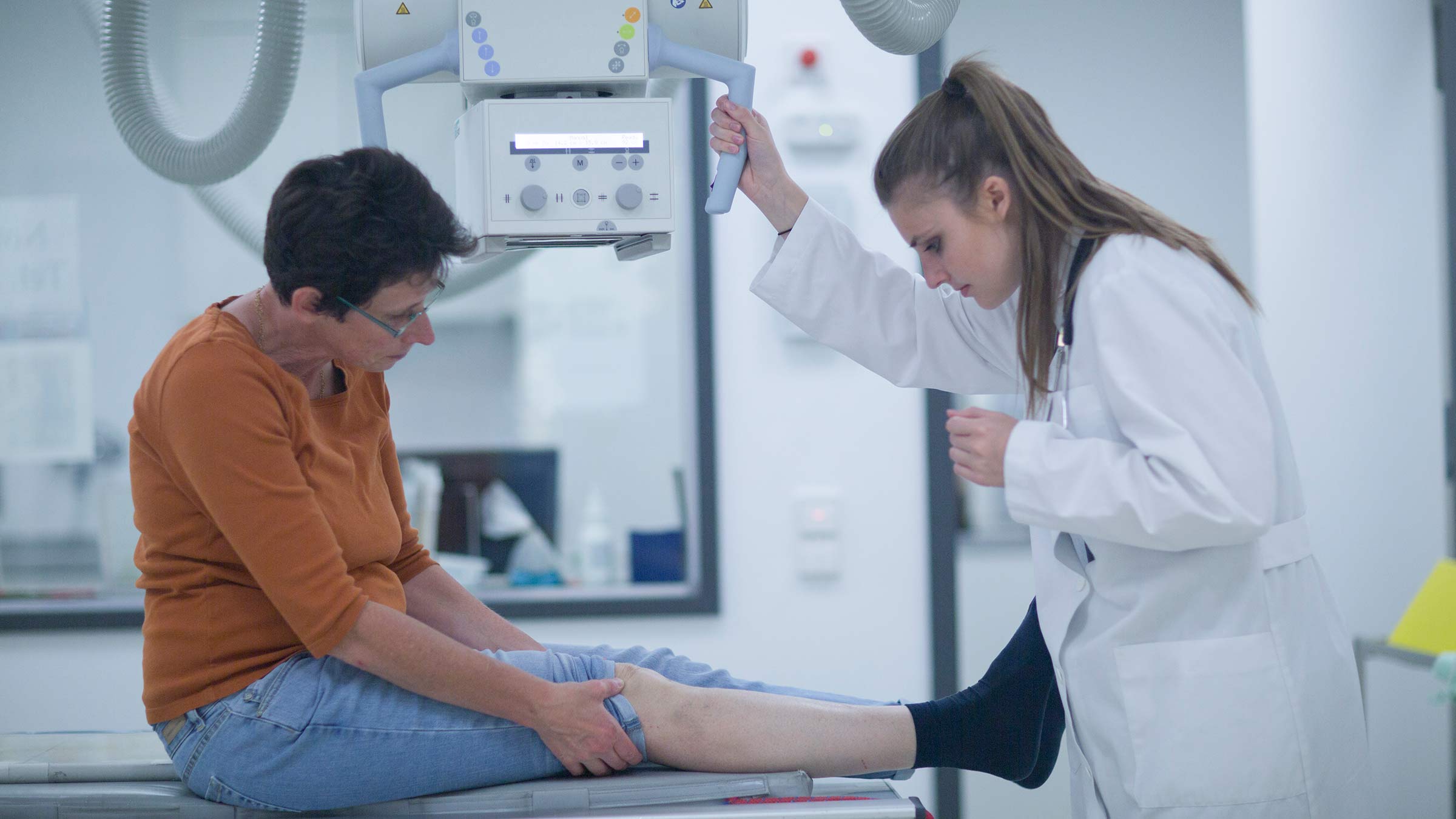 A doctor preparing a patient for an x-ray