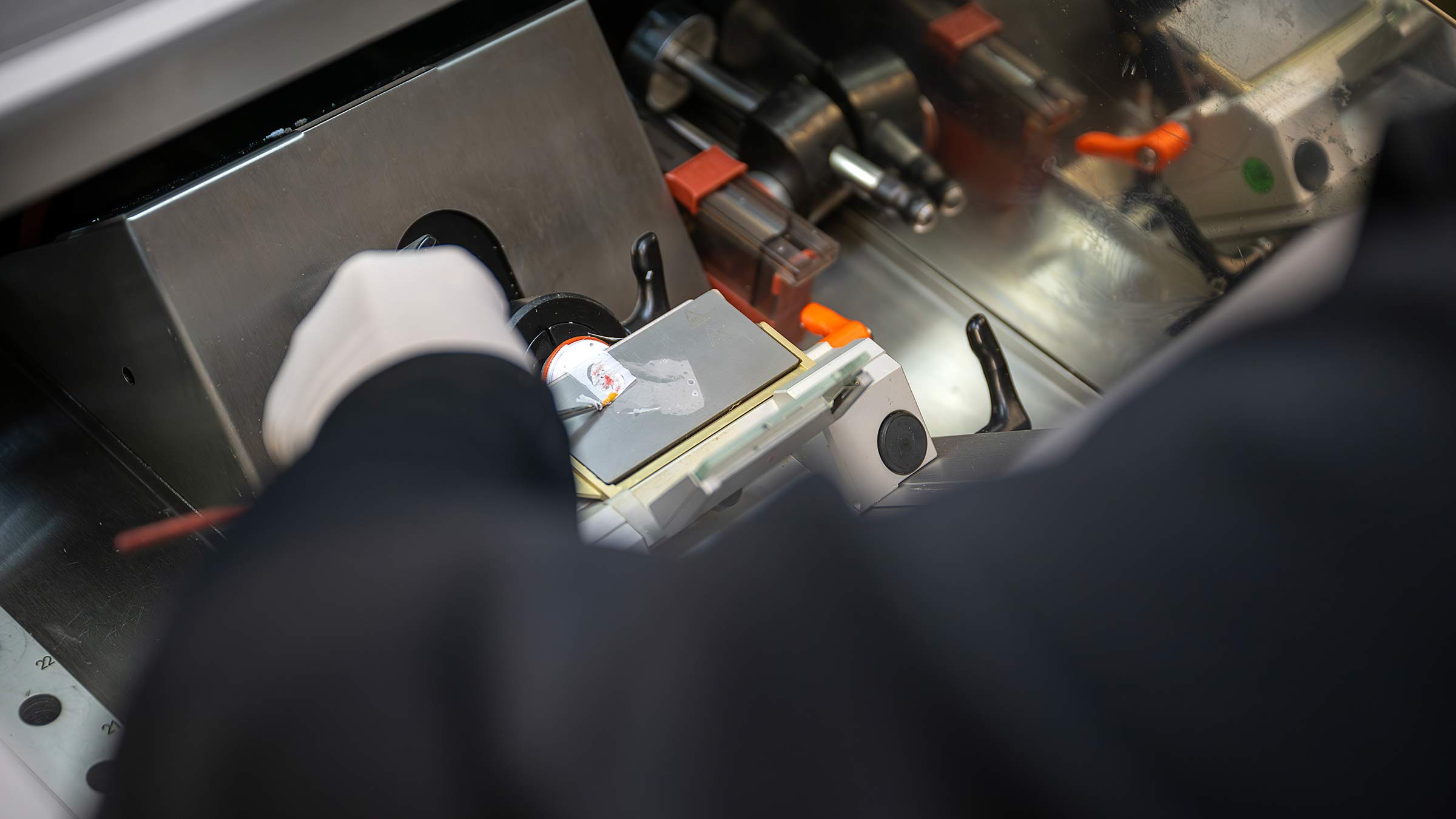 A person placing a skin sample into a machine