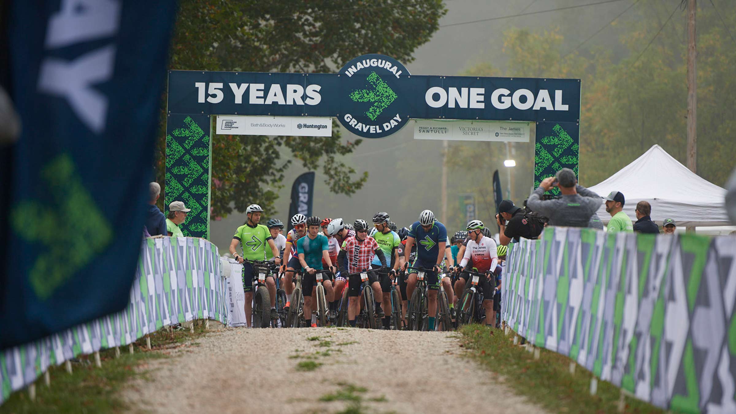 Riders getting ready under the "15 years - one goal" sign