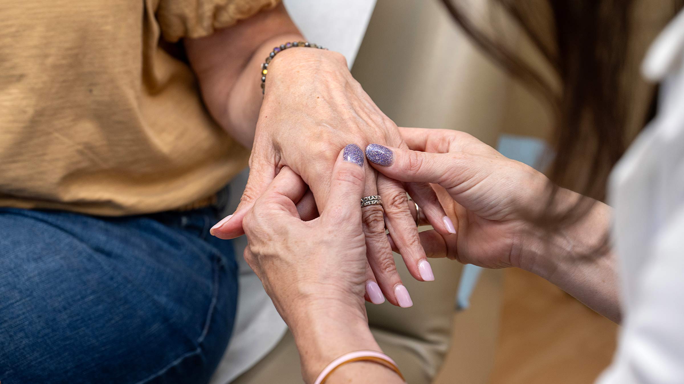 Dr. Meara examining a patient's hand