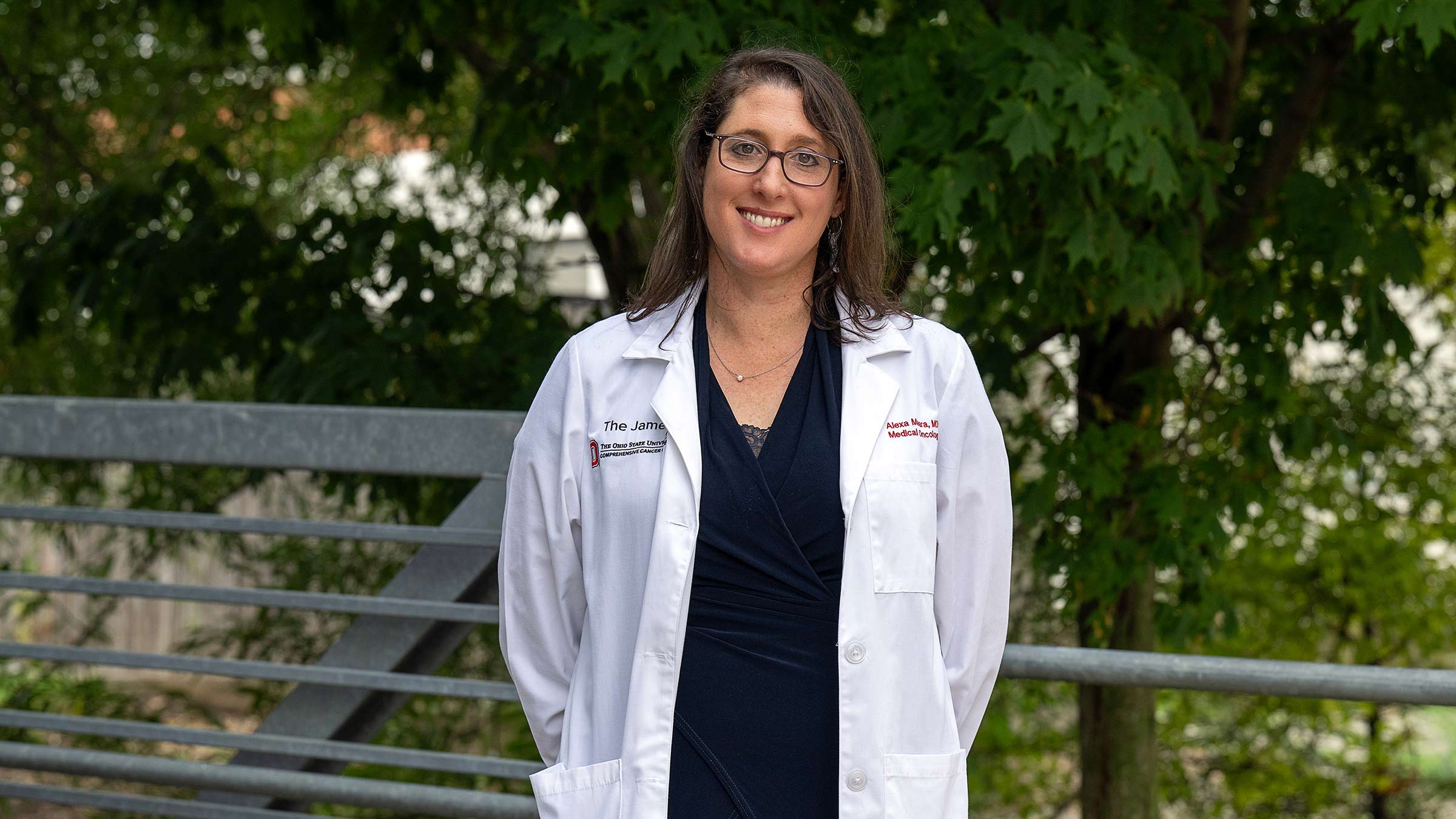 Dr. Alexa Meara posing for a photo outside with trees in the background