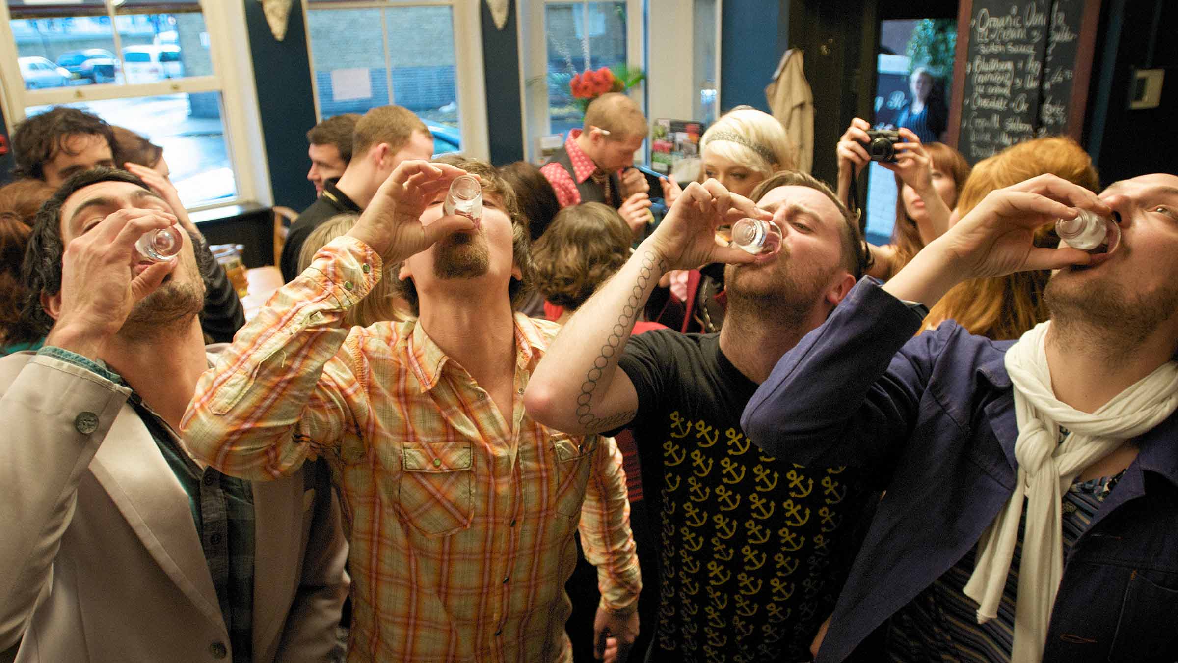 A group of friends drinking shots in a bar