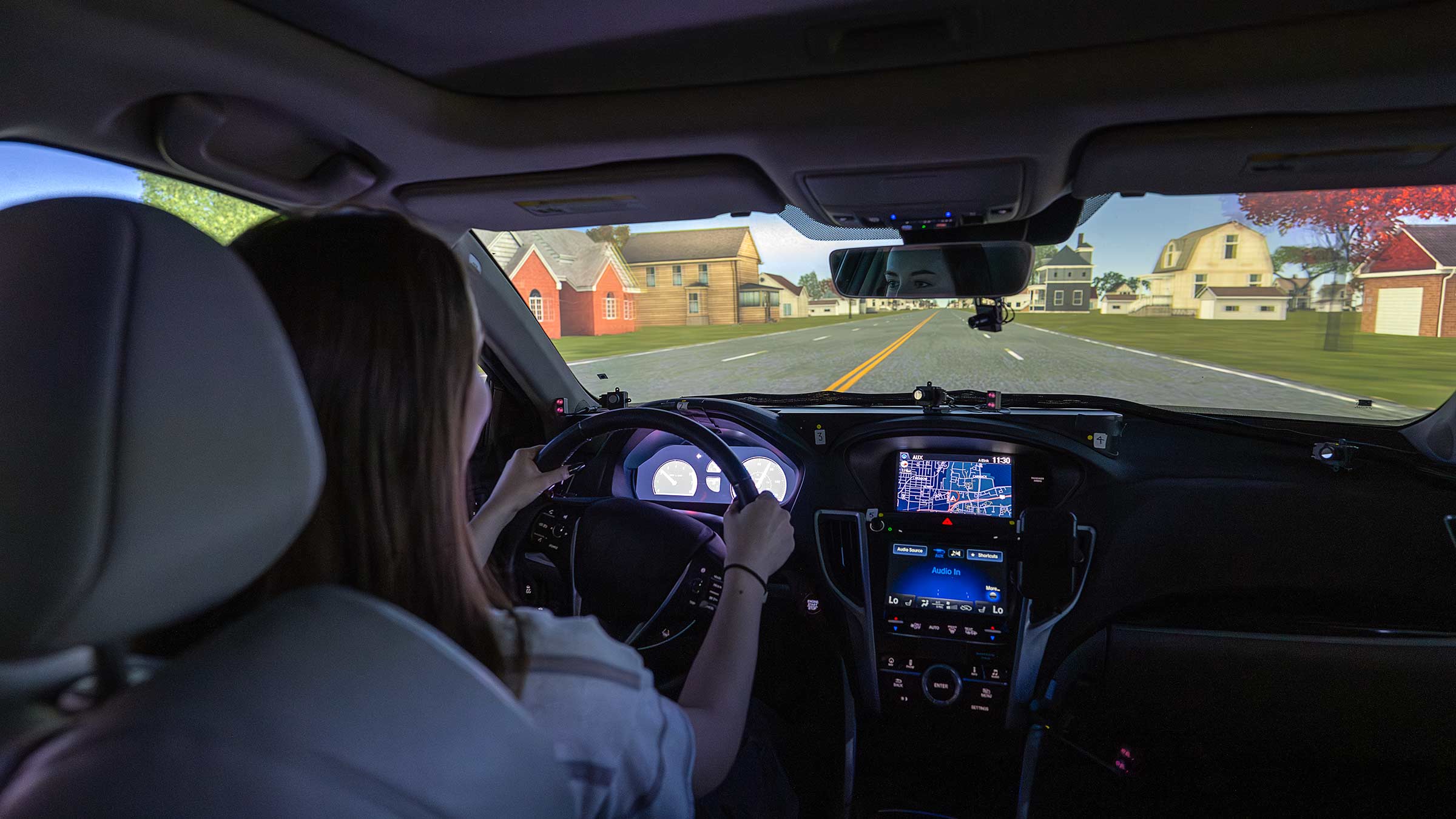 A young woman in a driving simulator