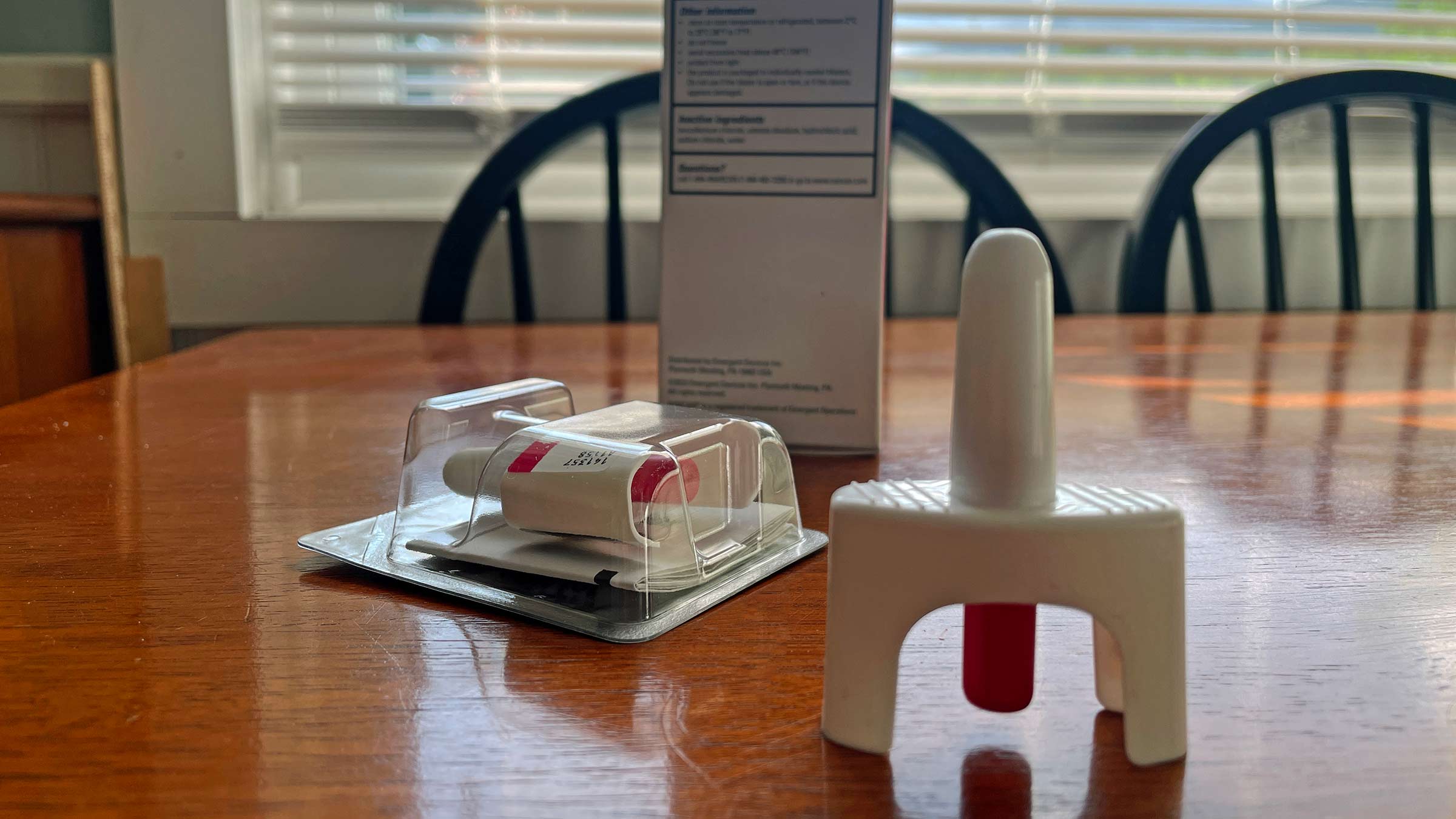 An over-the-counter prescription of Narcan sitting on a dining room table