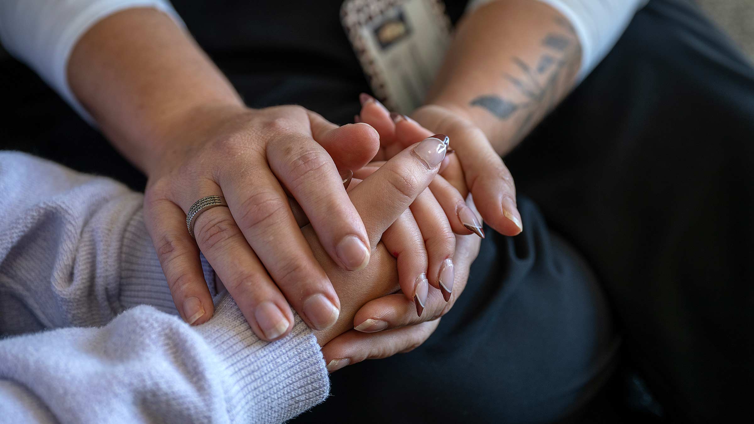 Melissa Pullman holding young person's hands in hers