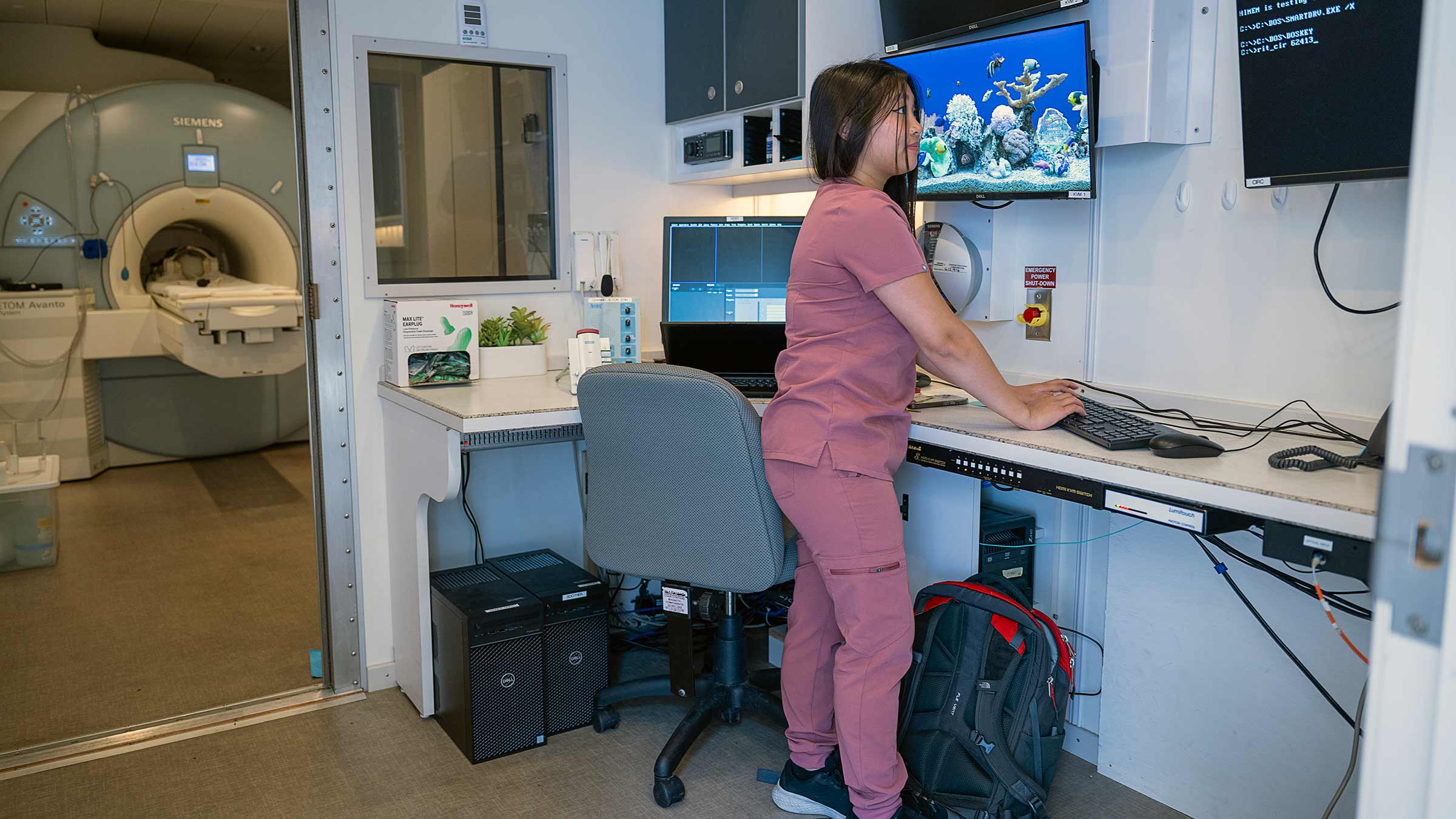 A tech standing in a mobile MRI unit