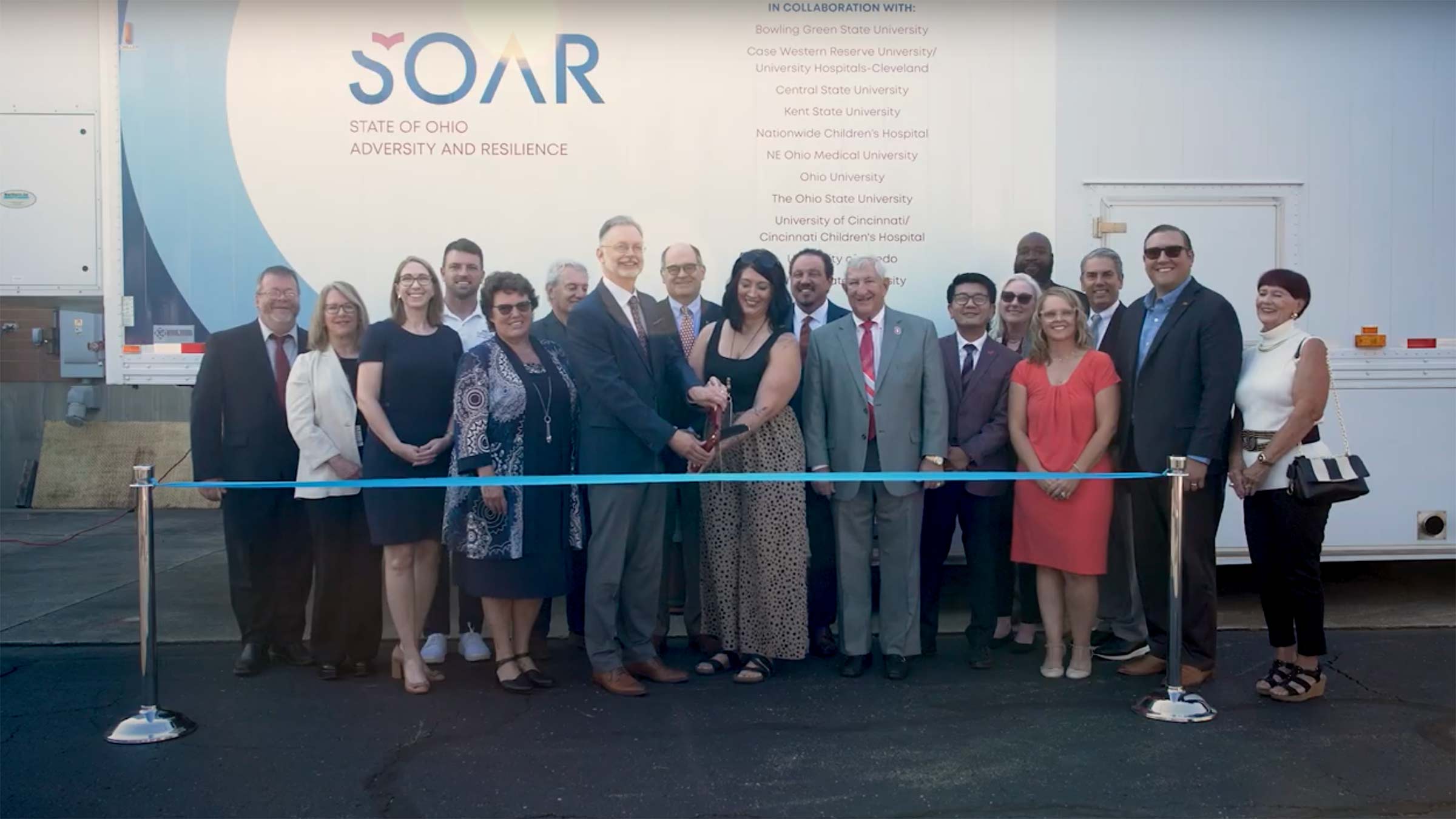 Ribbon cutting ceremony in front of the mobile MRI unit