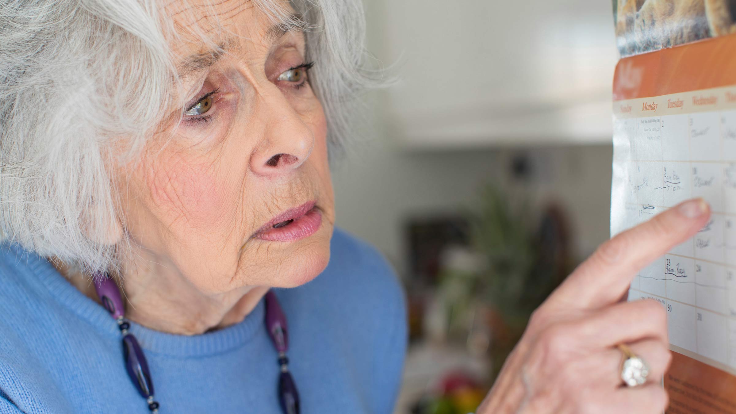 Confused senior woman looking at a calendar