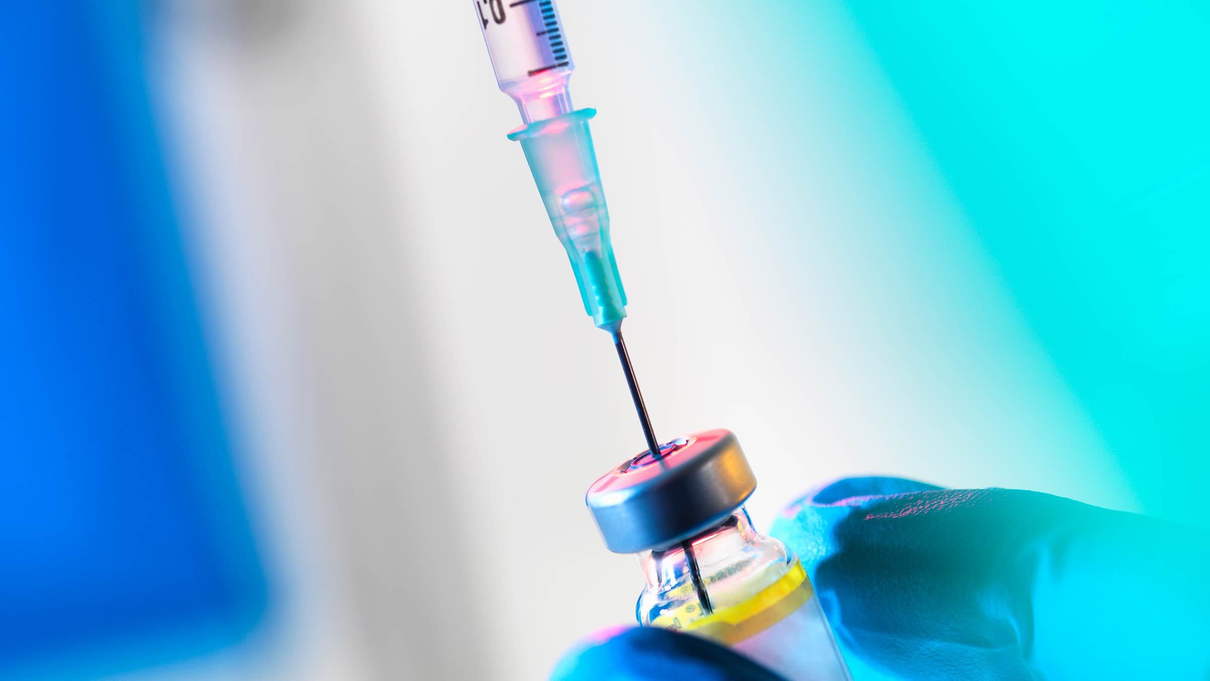 Syringe inserted into a vaccine vial