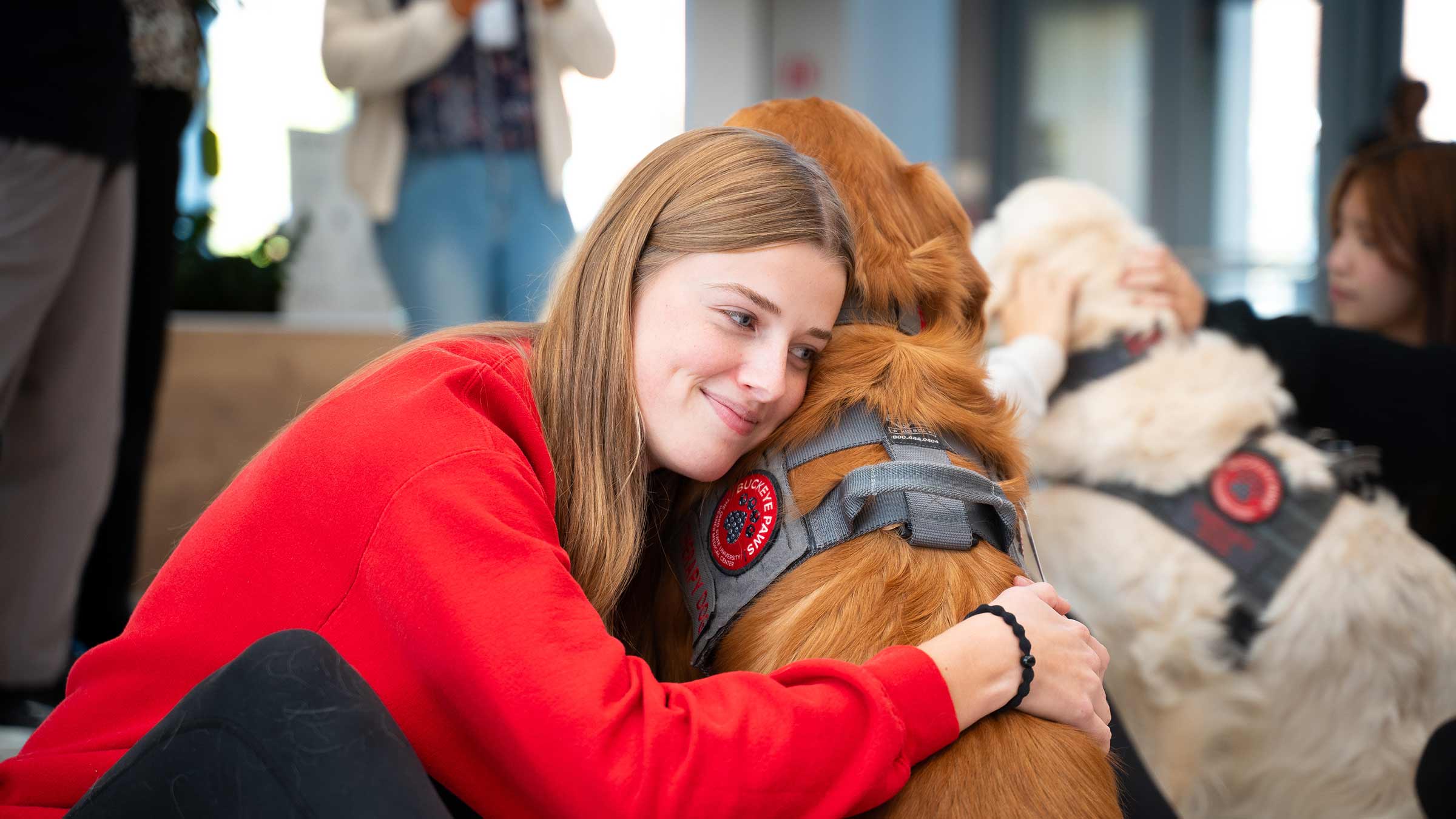 A young woman hugging a dog