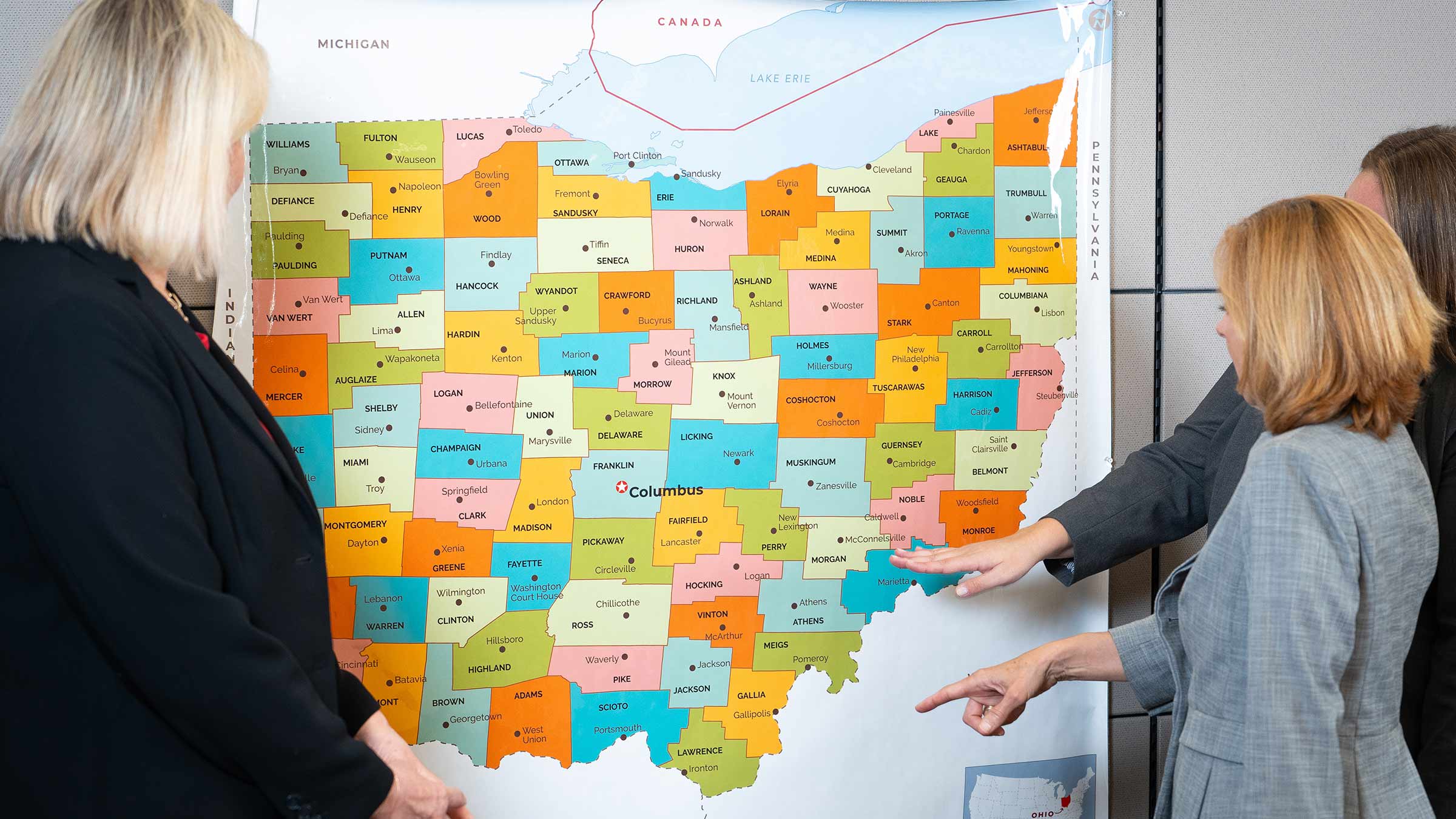 Mary Beth Happ, Karen Rose and Morgan Fitzgerald pointing to a map of Ohio