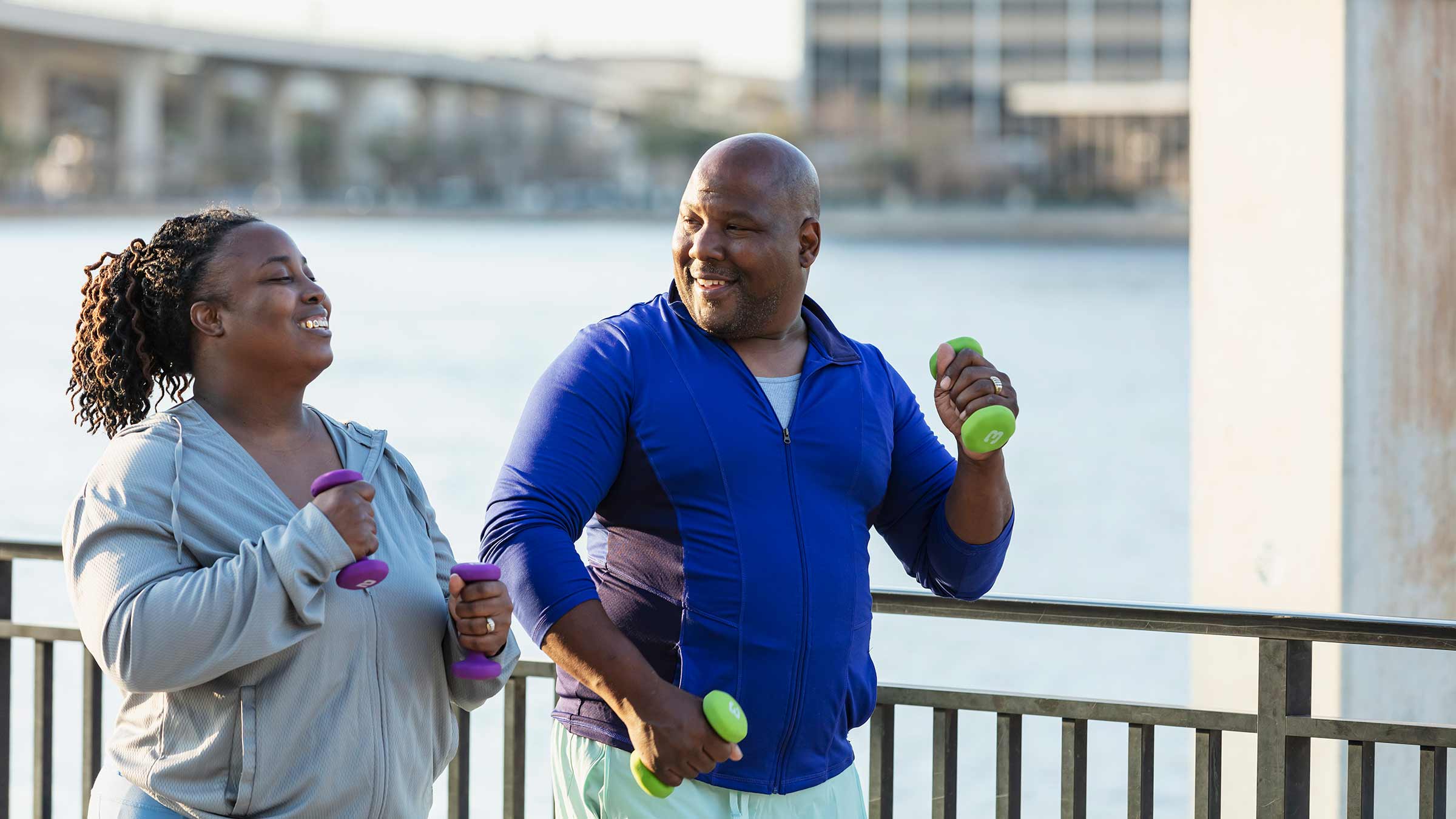 A man and a woman exercising outside