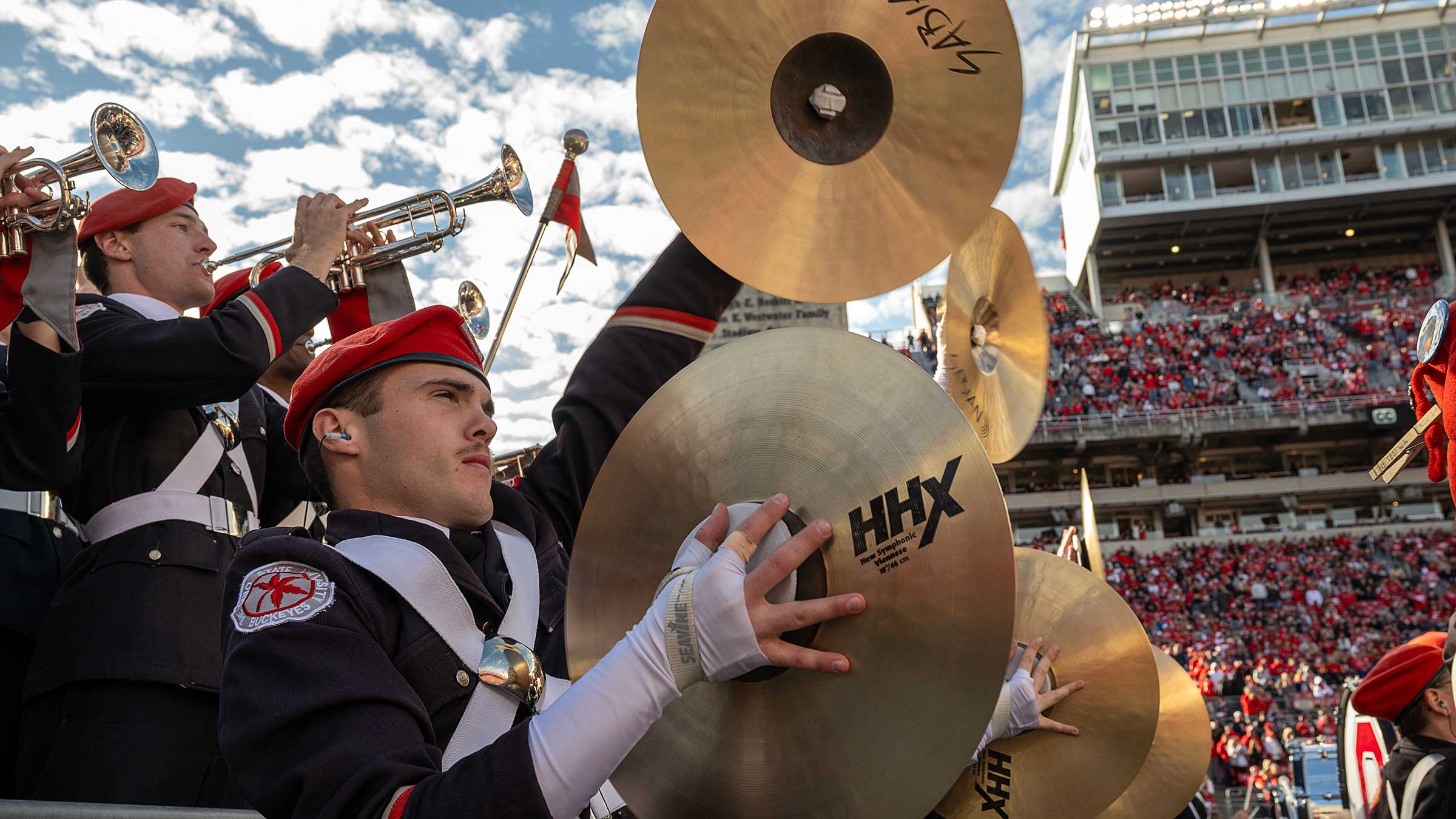 Grayson Niemi playing cymbals during a football game