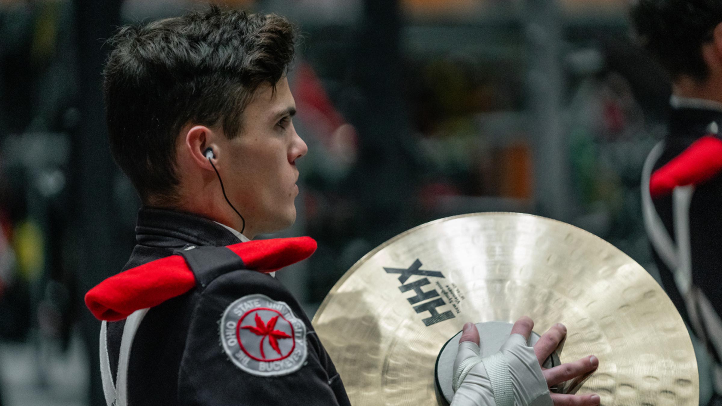 Grayson Niemi holding his cymbals in his marching band uniform