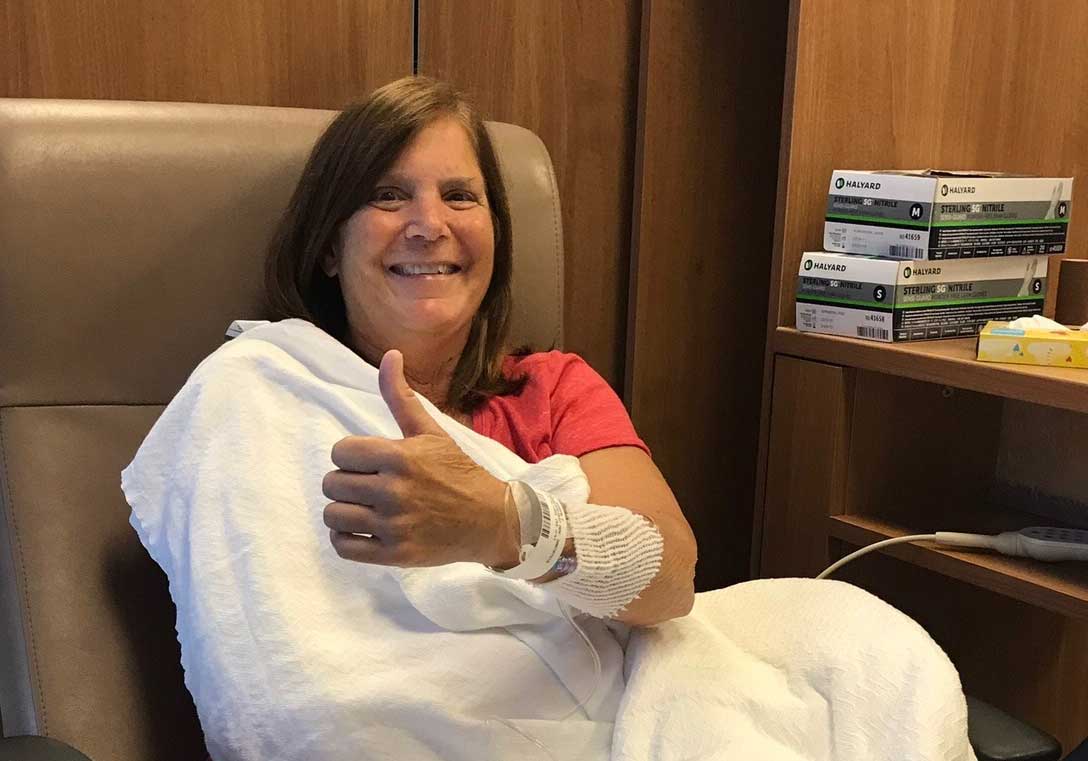 Brooke's mother, Sharon, in a hospital chair with IV in her arm