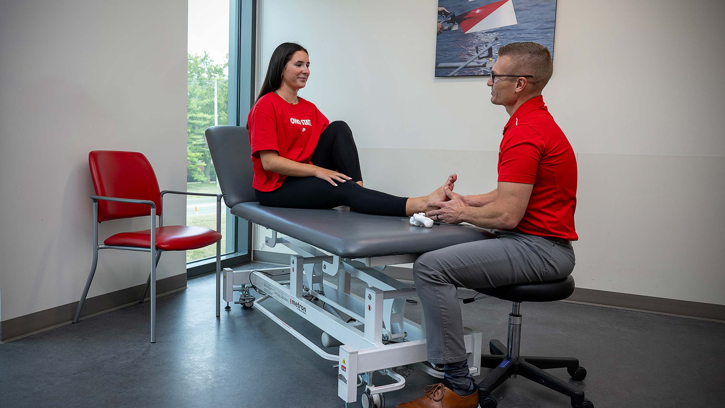 Dr. Martin checking on Melayna's ankle post-recovery