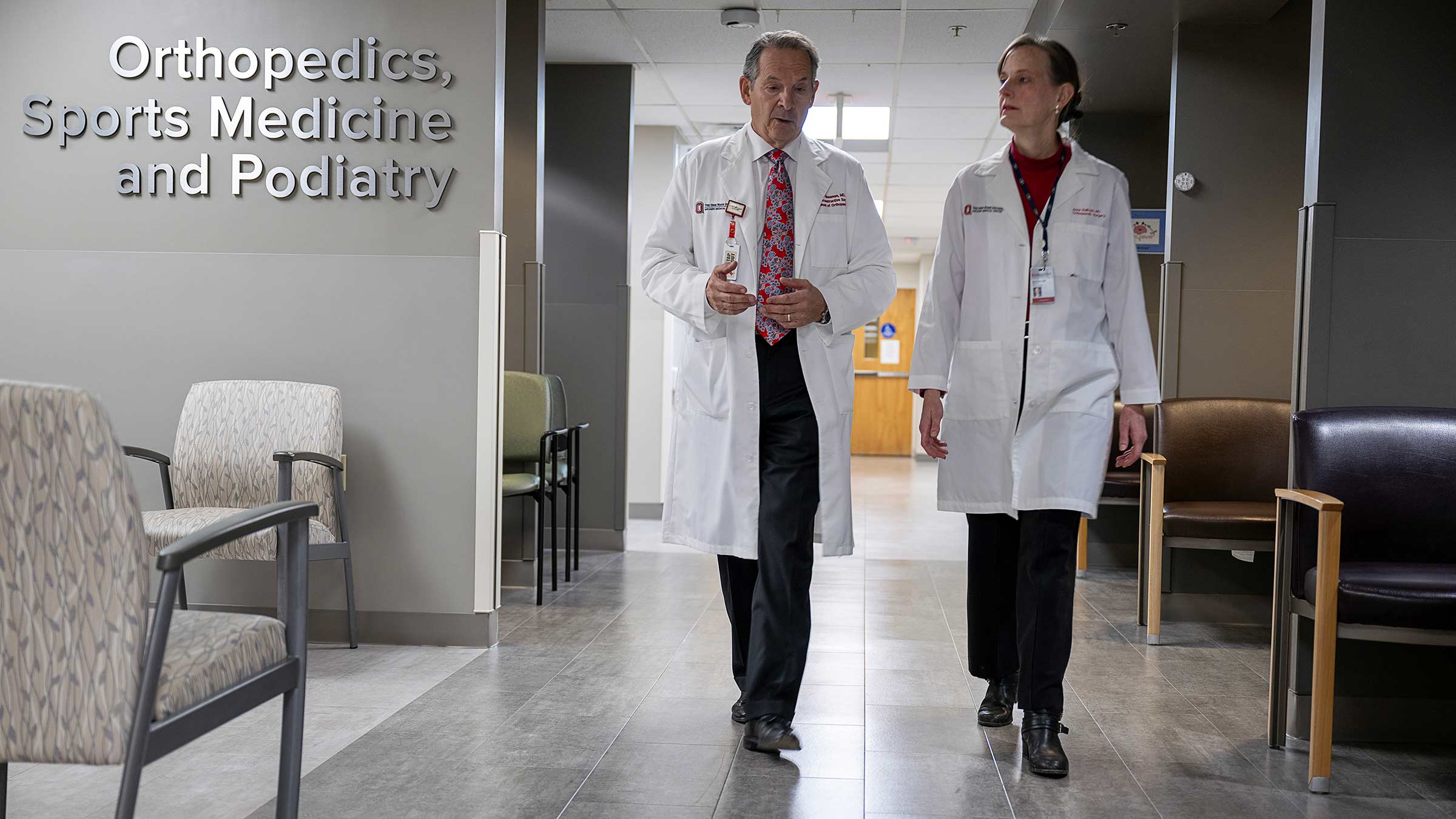 Dr. Andrew Glassman and Dr. Anne Sullivan walking and conversing