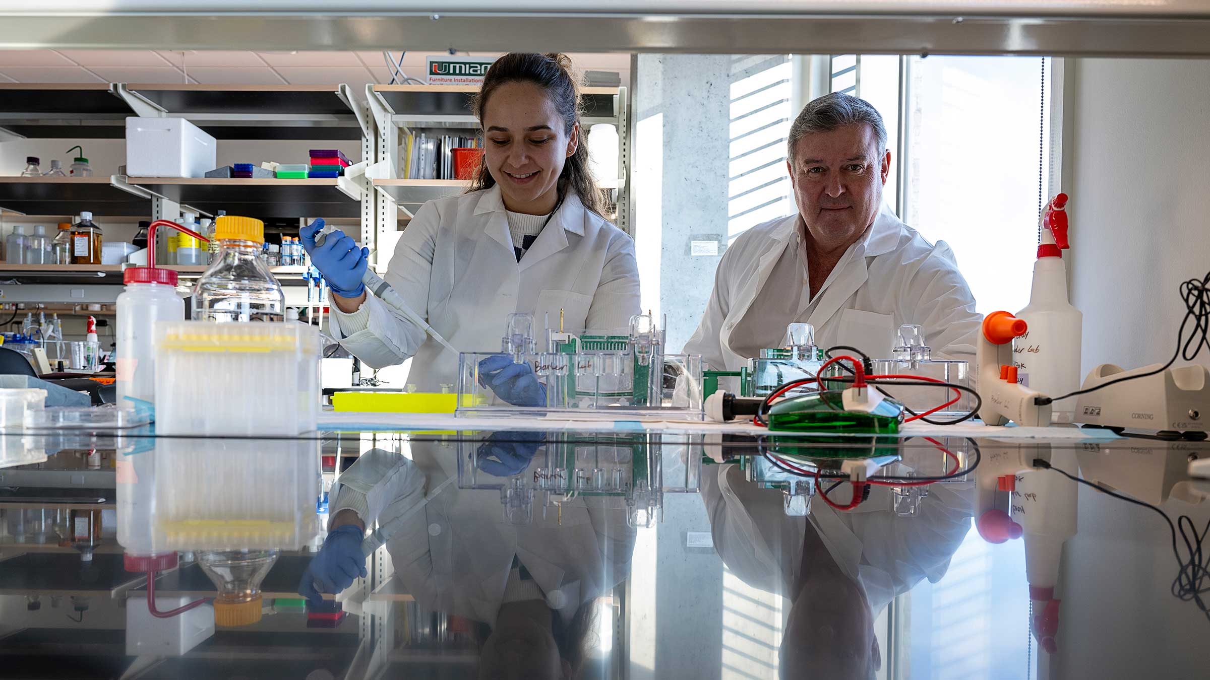 Glen Barber with a PhD student in a lab