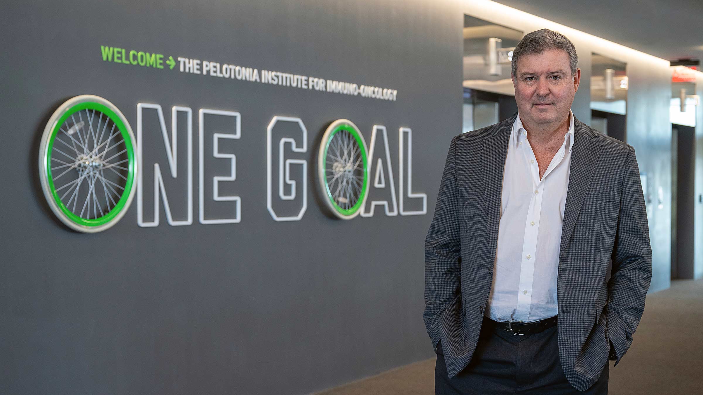 Glen Barber standing next to the "One Goal" sign