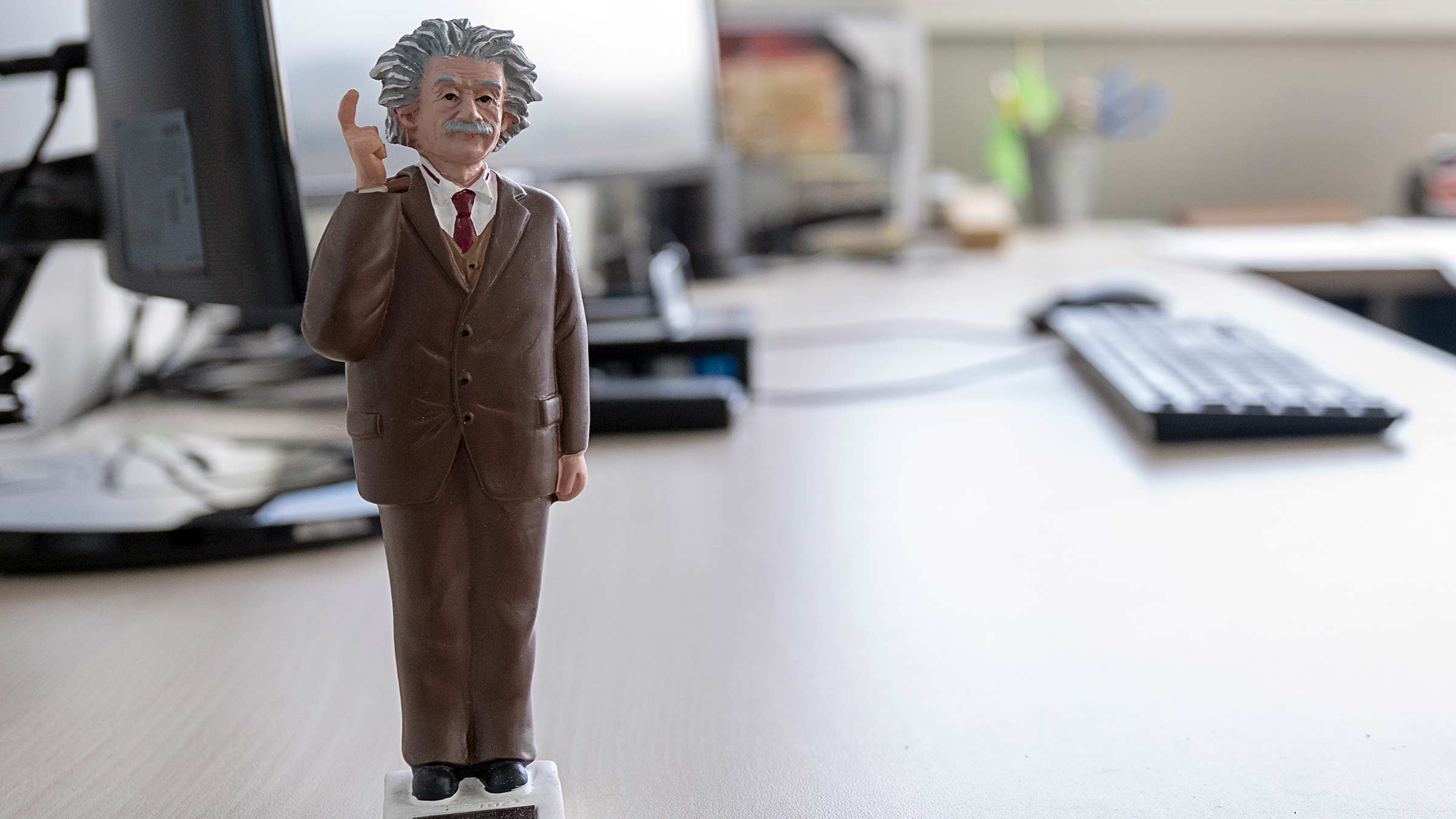 A statuette of Albert Einstein on a desk